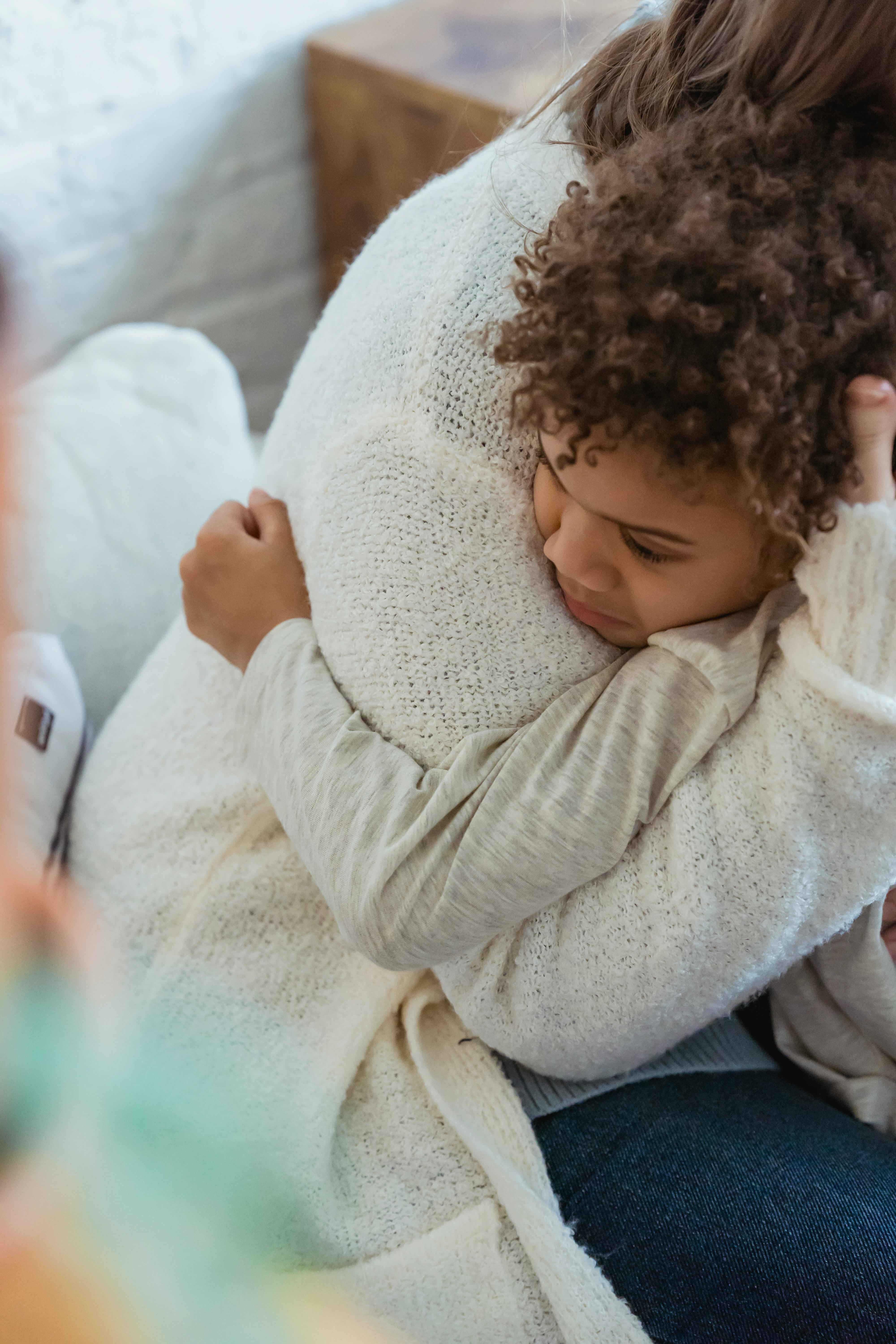 A woman embracing a child | Source: Pexels