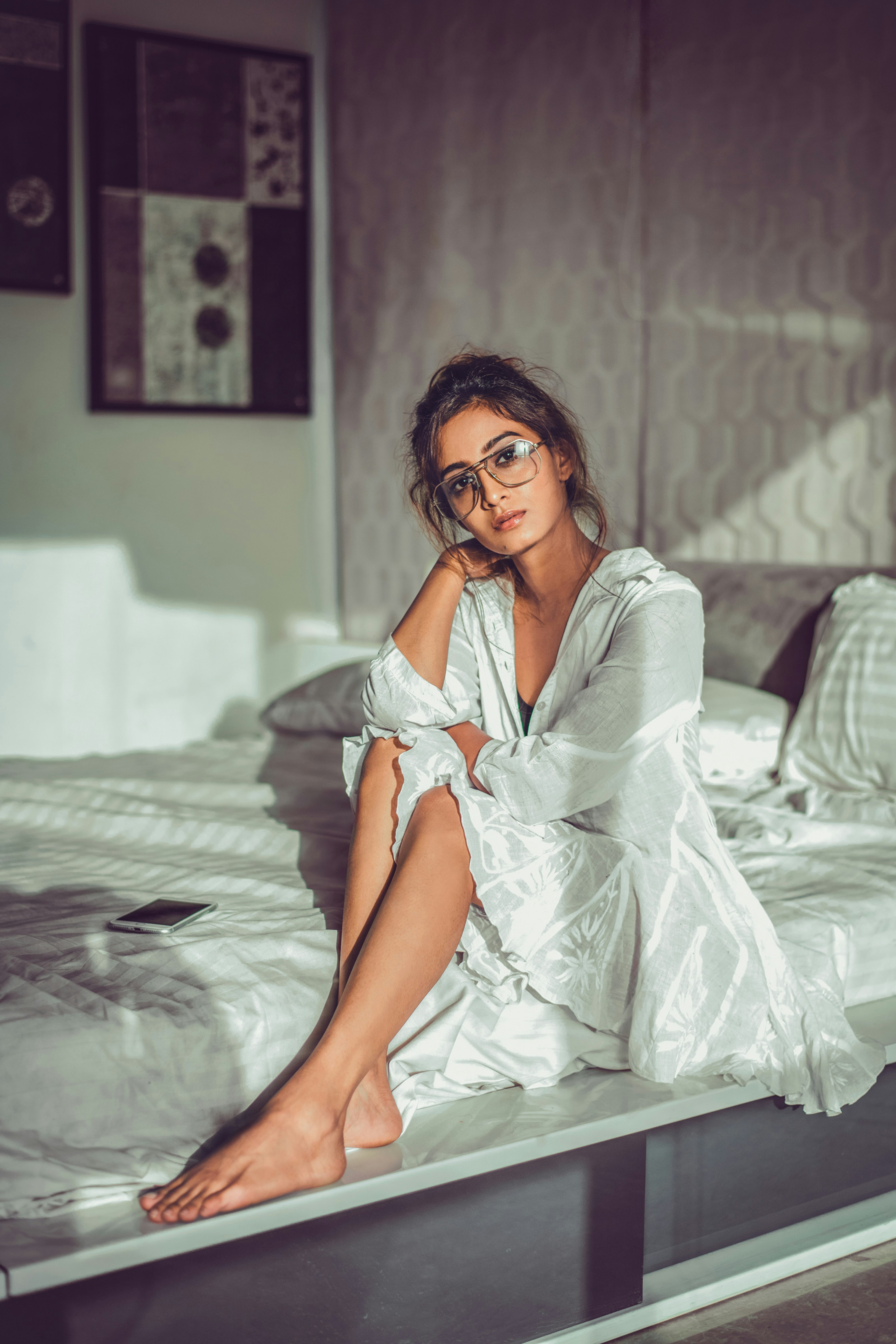 Woman sitting on bed | Source: Unsplash