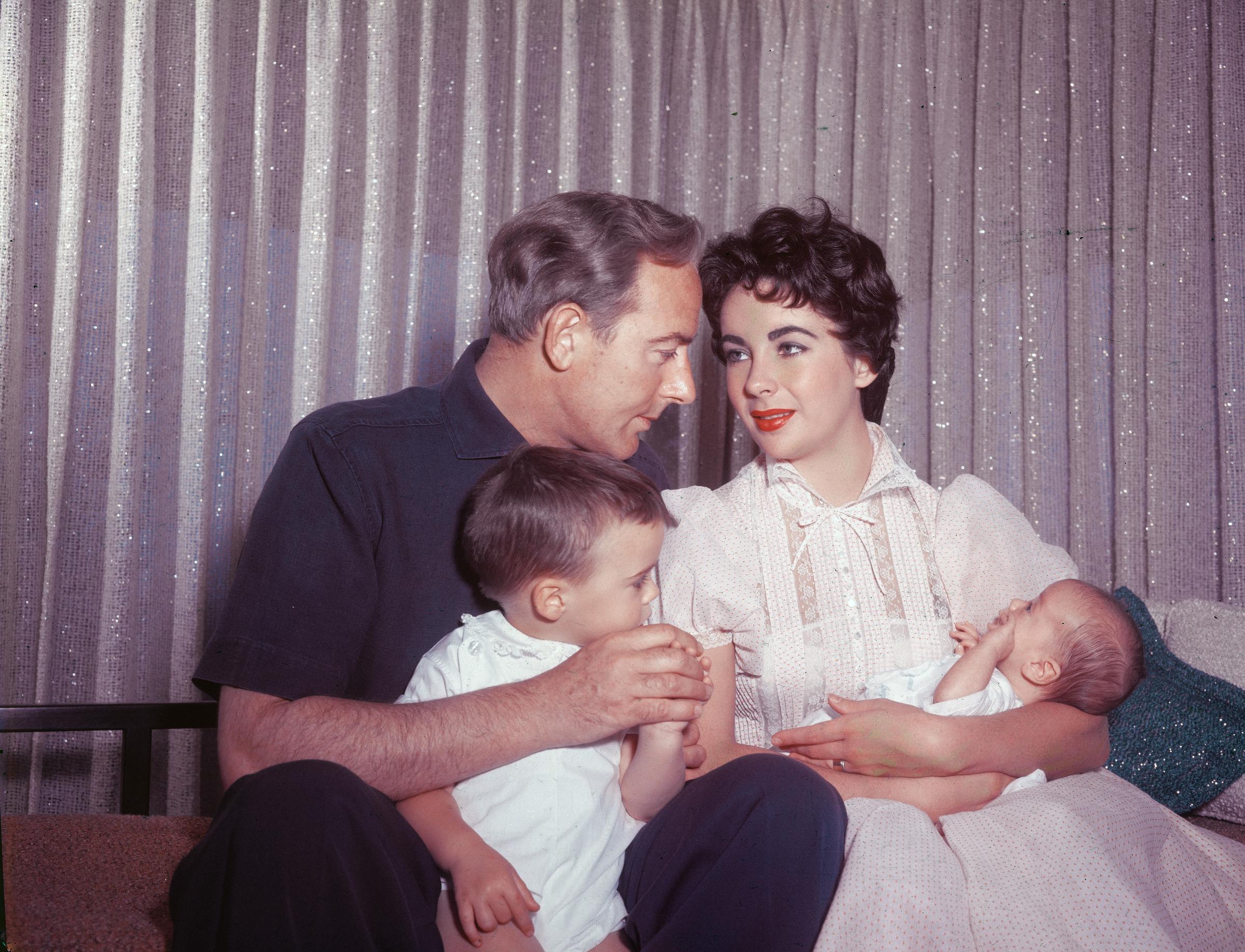 Elizabeth Taylor and Michael Wilding with their sons Michael Jr and newborn Christopher in Los Angeles, California, circa 1955. | Source: Getty Images