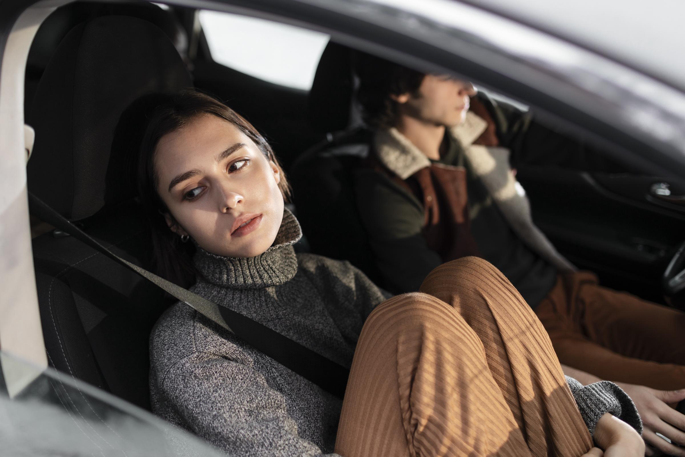 An unhappy woman in a car | Source: Freepik