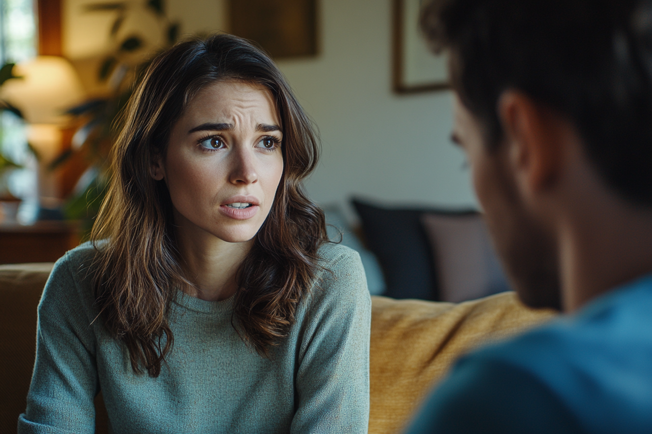 A woman speaking to a man in a living room | Source: Midjourney