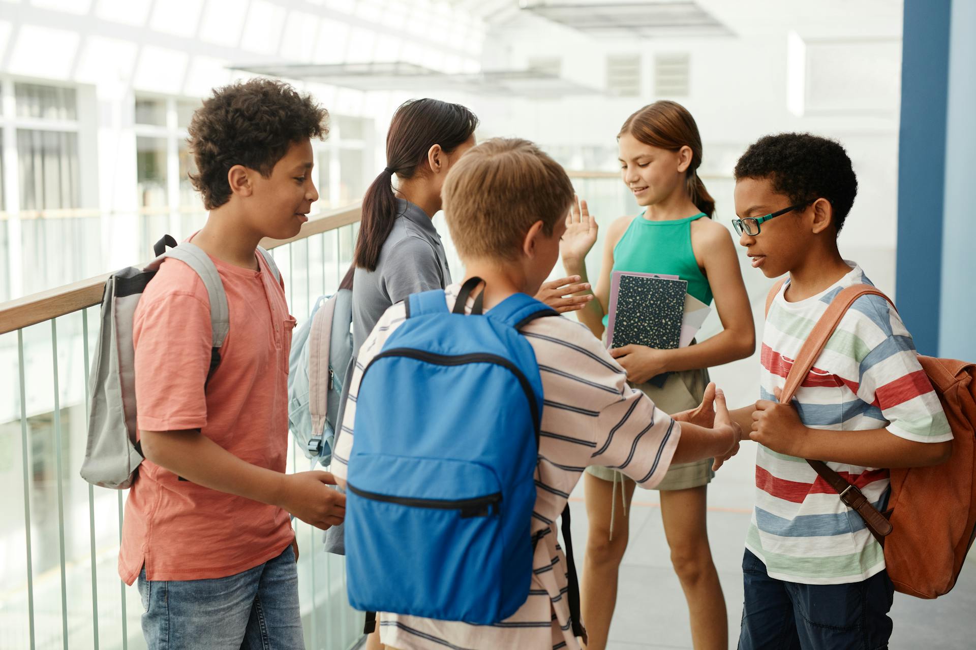 Children huddled together in a school corridor | Source: Pexels