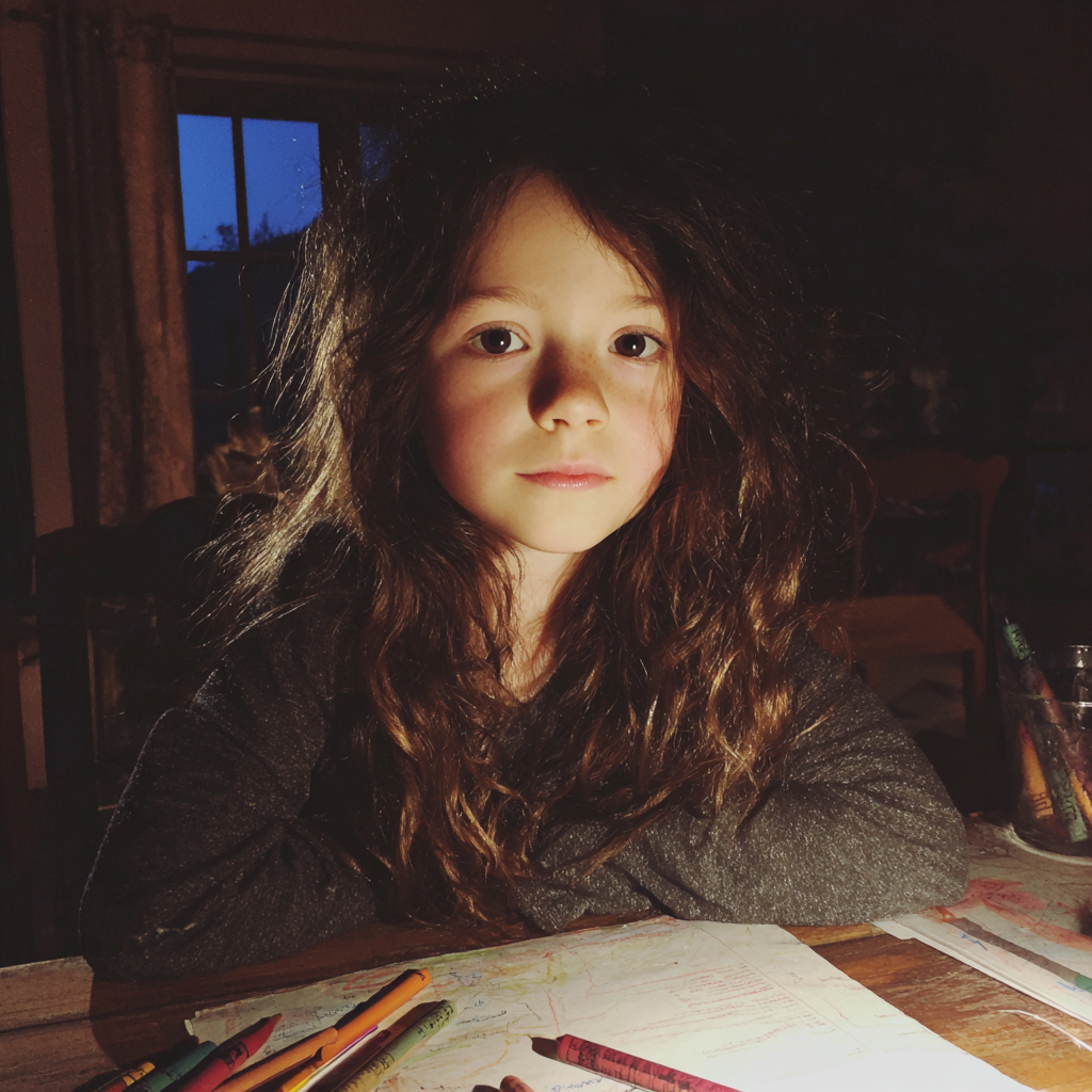 A little girl sitting at a dining table | Source: Midjourney