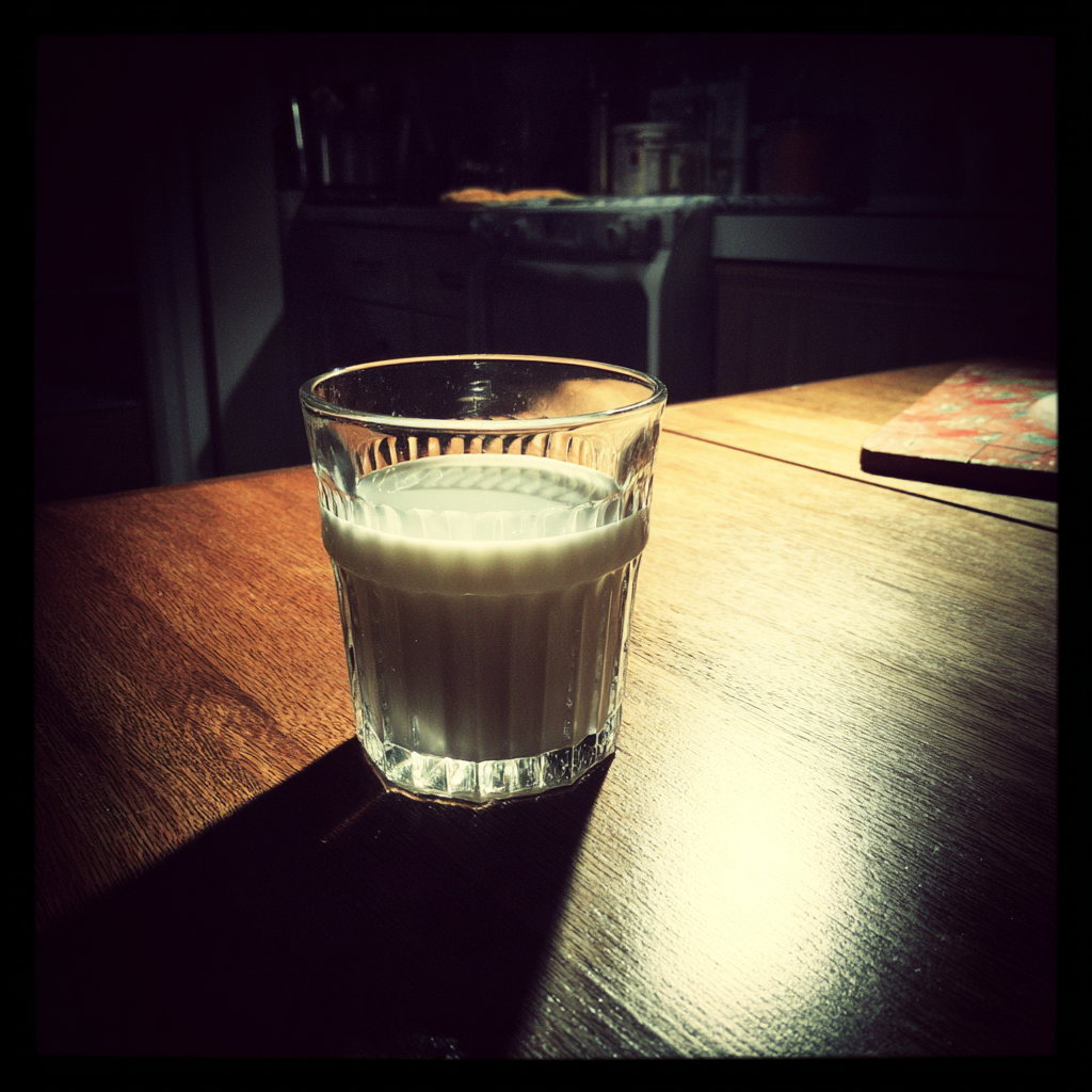 A glass of milk on a table | Source: Midjourney