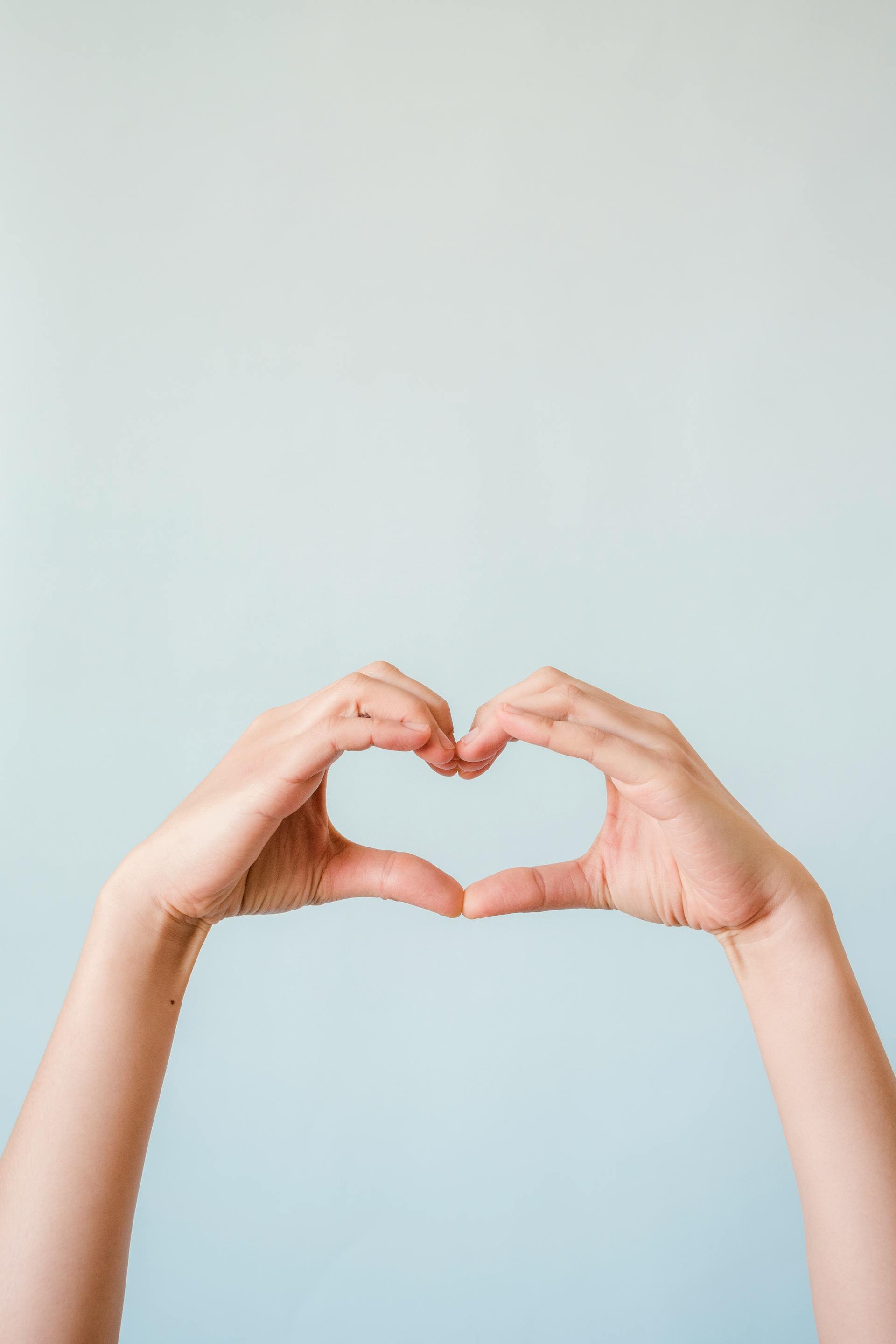 A child making a heart side with his hands | Source: Pexels