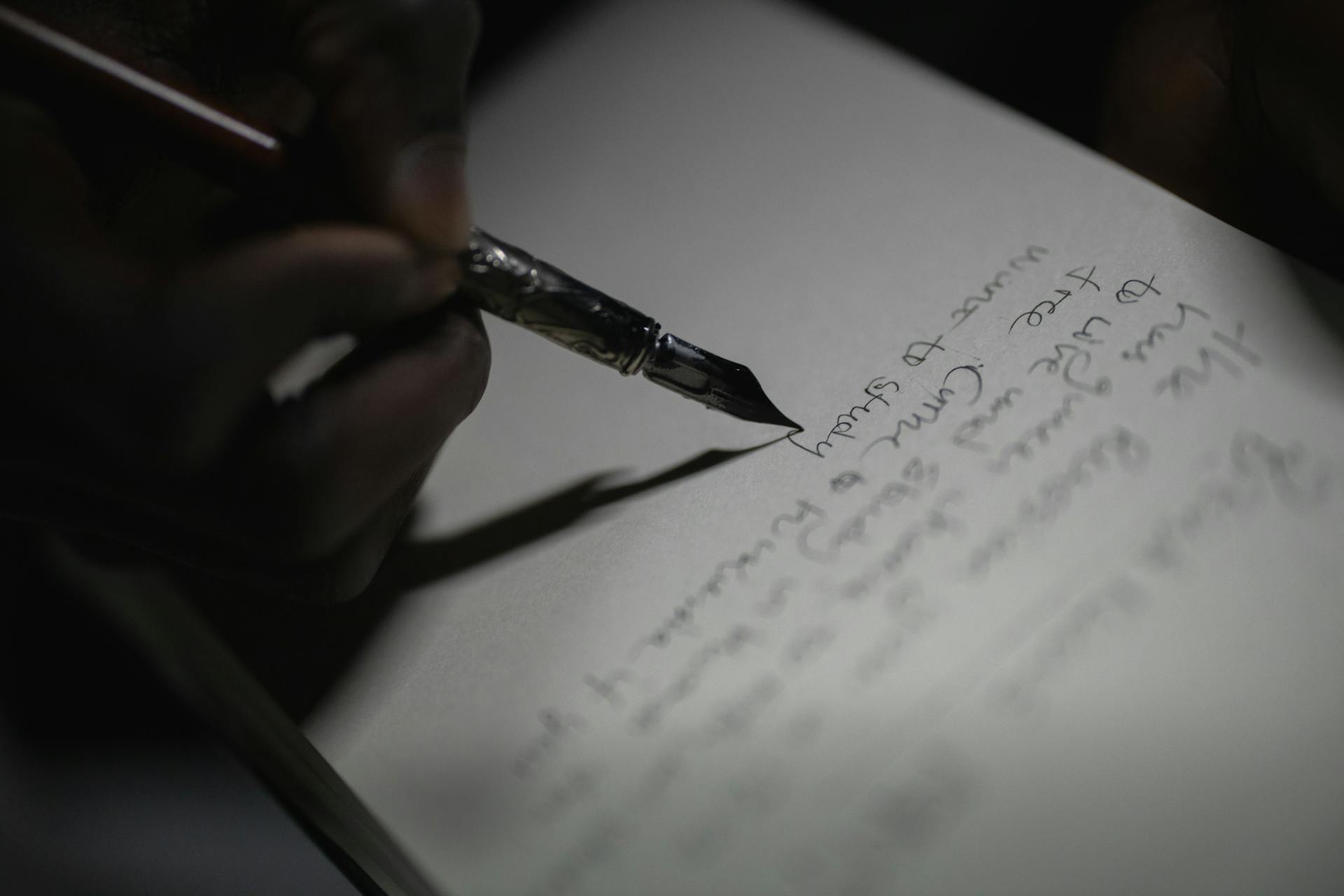 A person writing on a paper | Source: Pexels