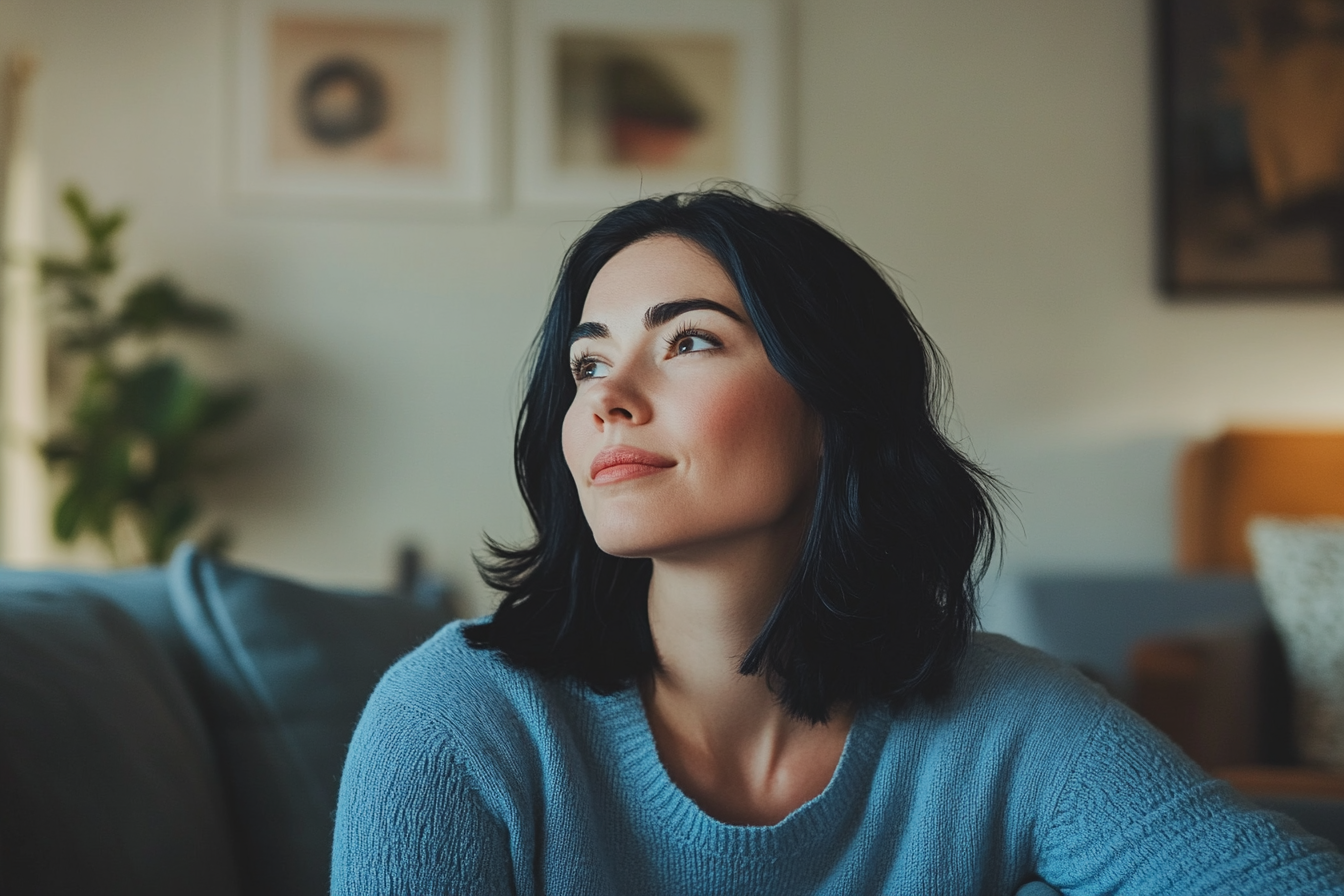 A woman sitting on a couch | Source: Midjourney