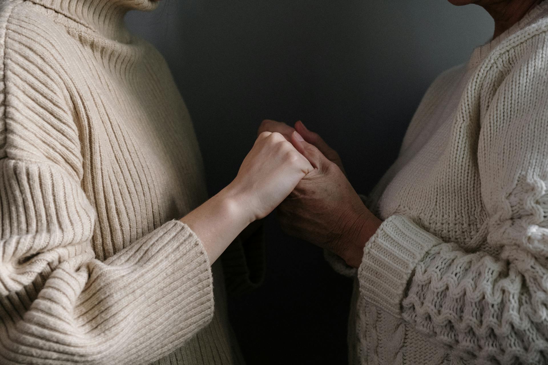 A woman holding her mother's hands | Source: Pexels