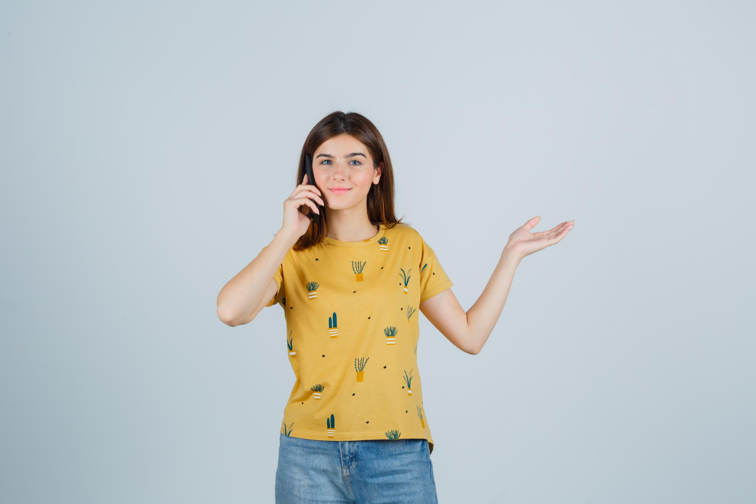 A delighted young woman talking on the phone | Source: Freepik