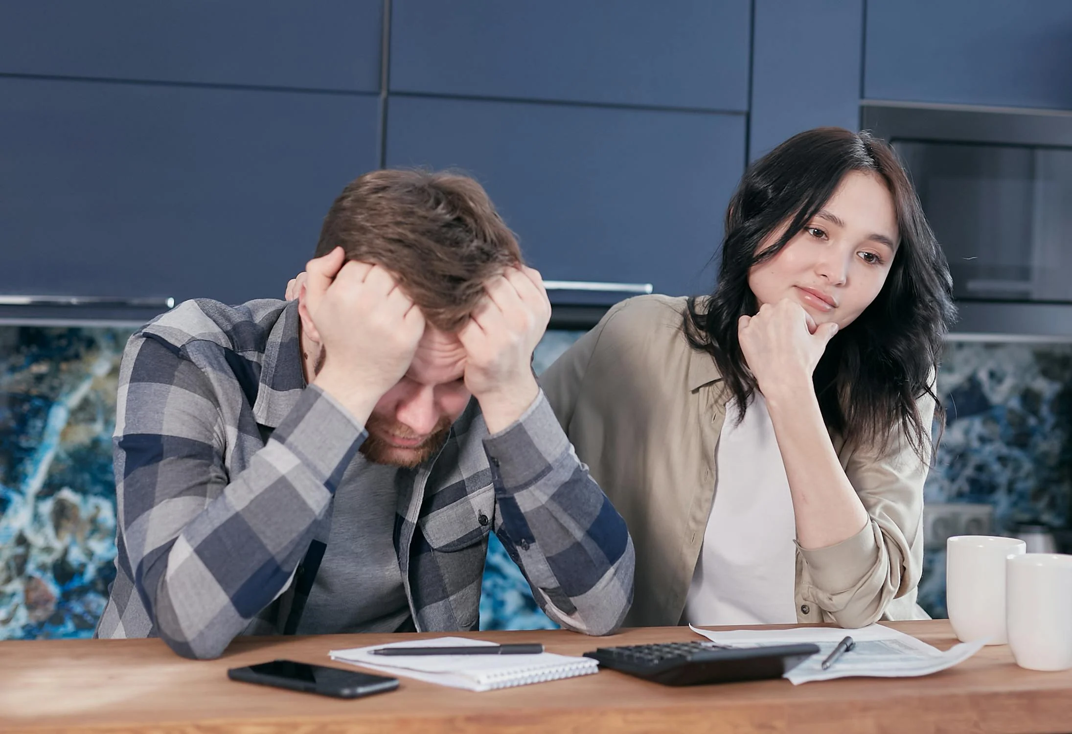 A strained couple looking at the papers | Source: Pexels