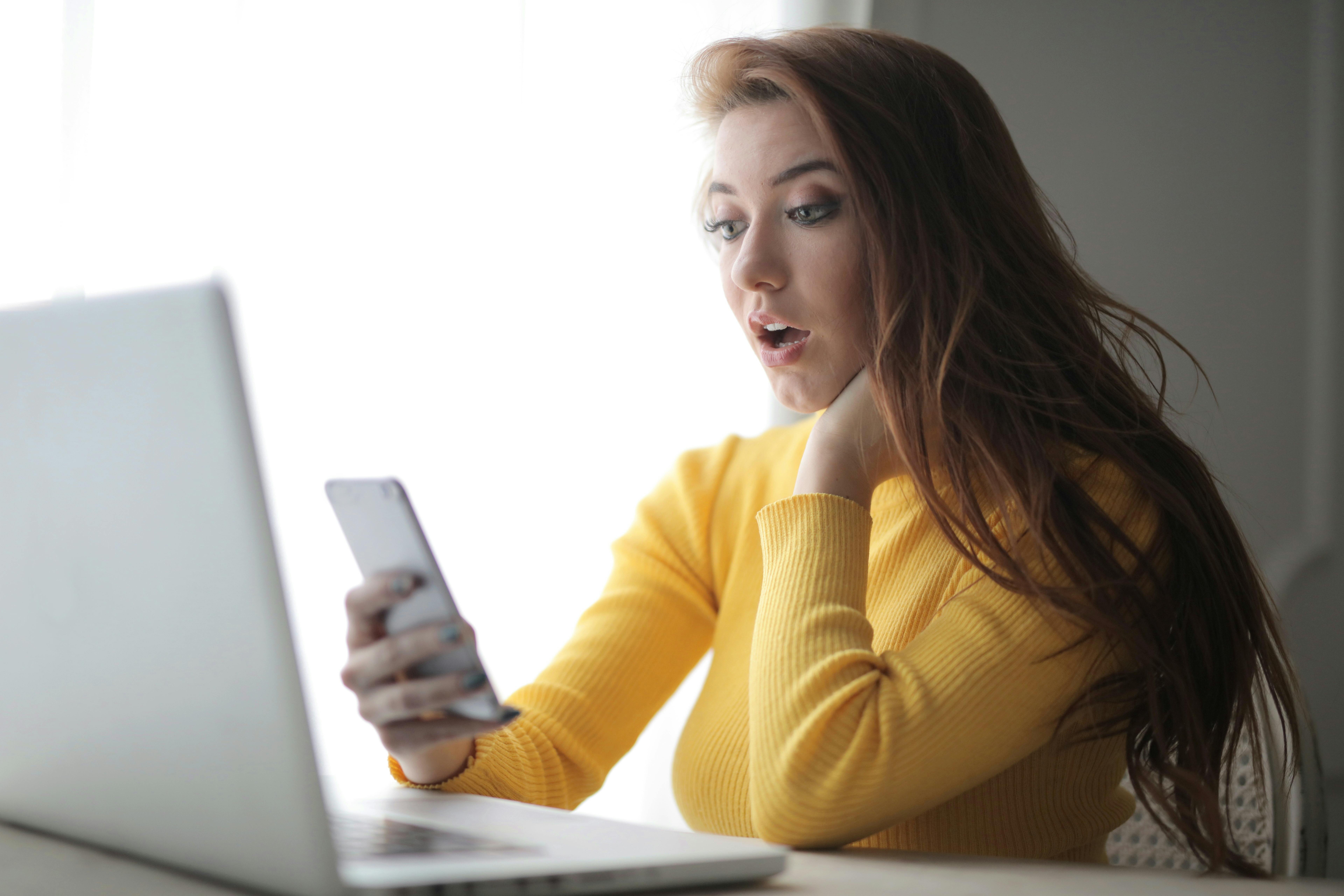 A woman reading a text message | Source: Pexels