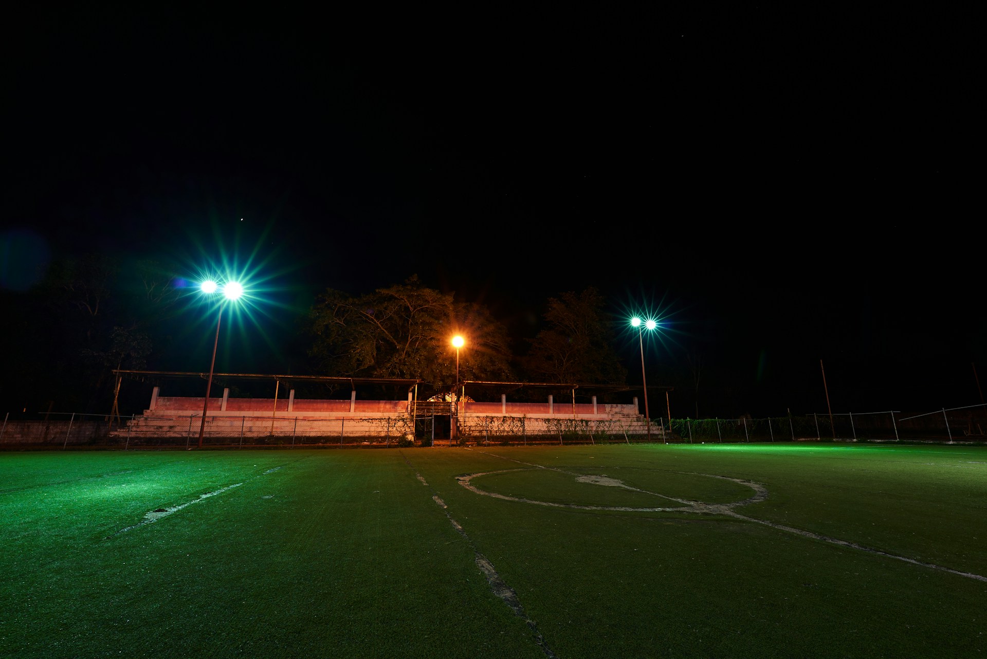 An empty football field at night | Source: Unsplash