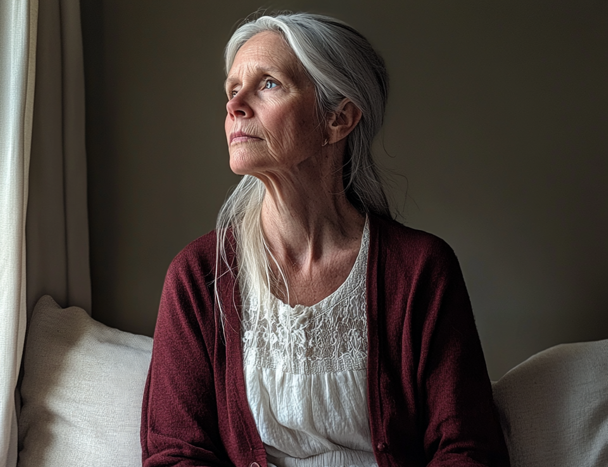 An older woman looking out a window | Source: Midjourney