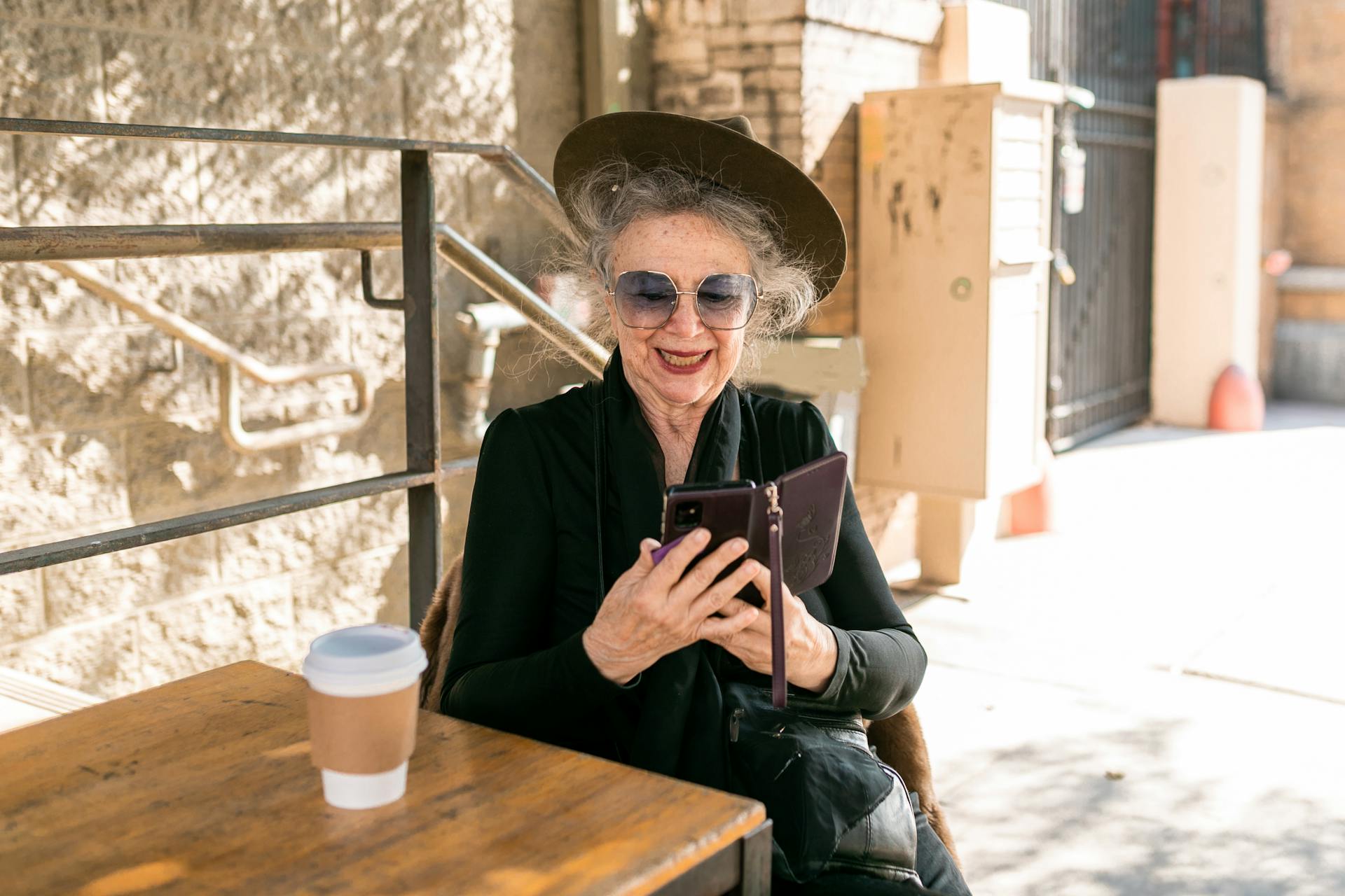 A happy older woman using her phone | Source: Pexels