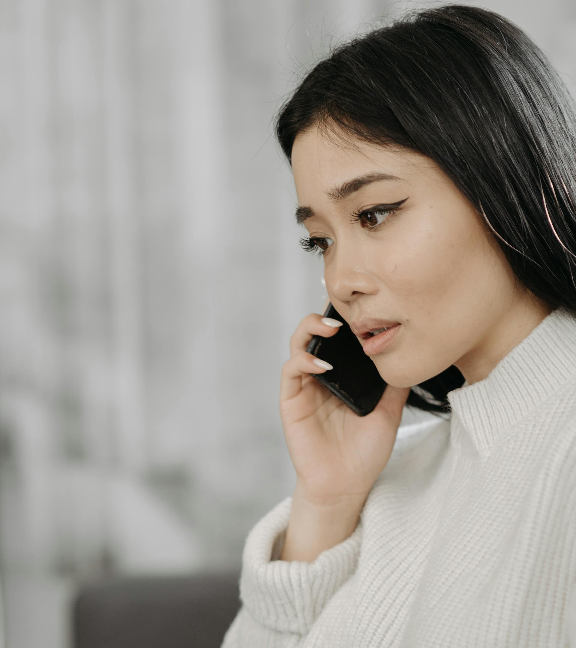 A stunned woman speaking on her phone | Source: Pexels