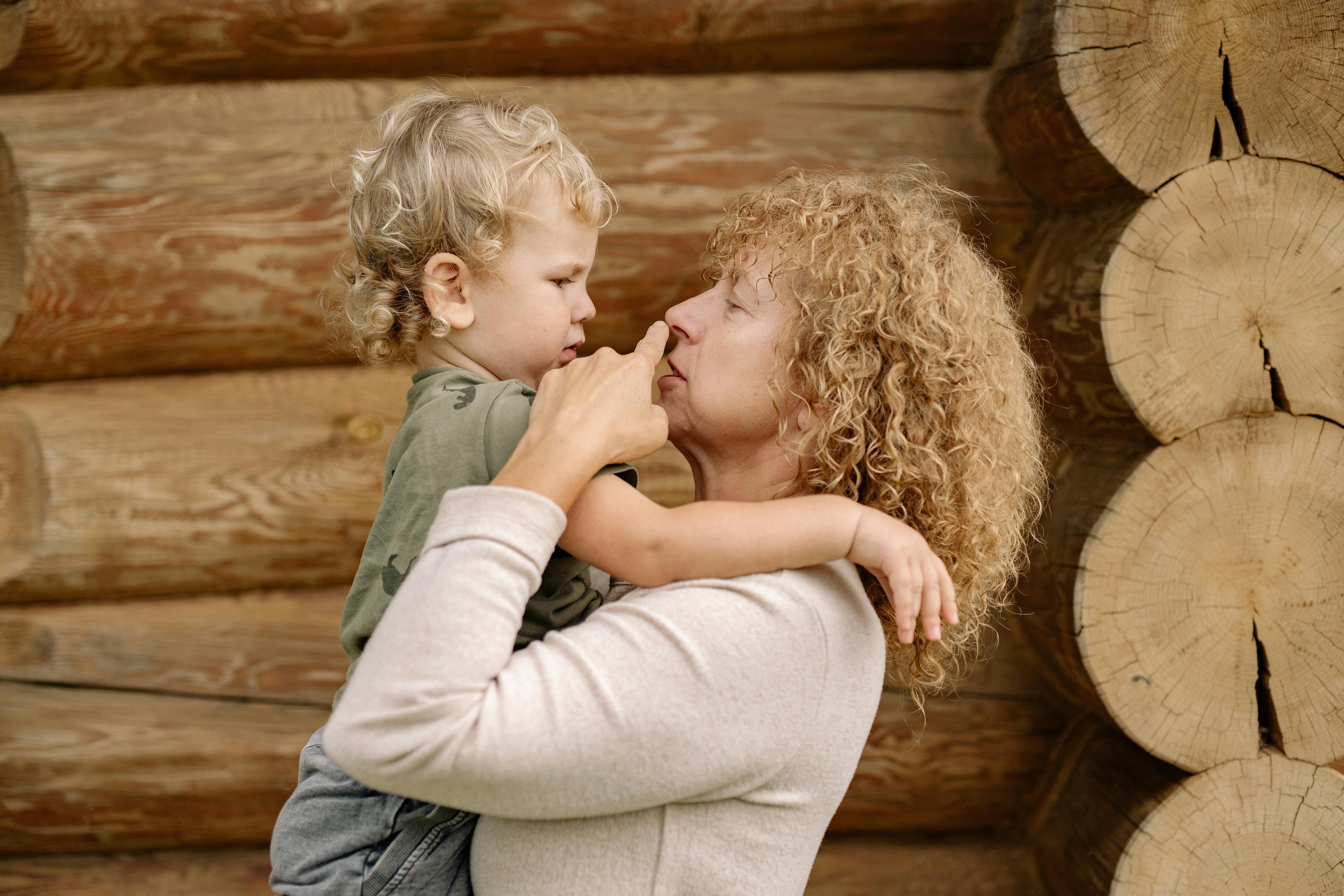 A grandmother carrying a child | Source: Pexels