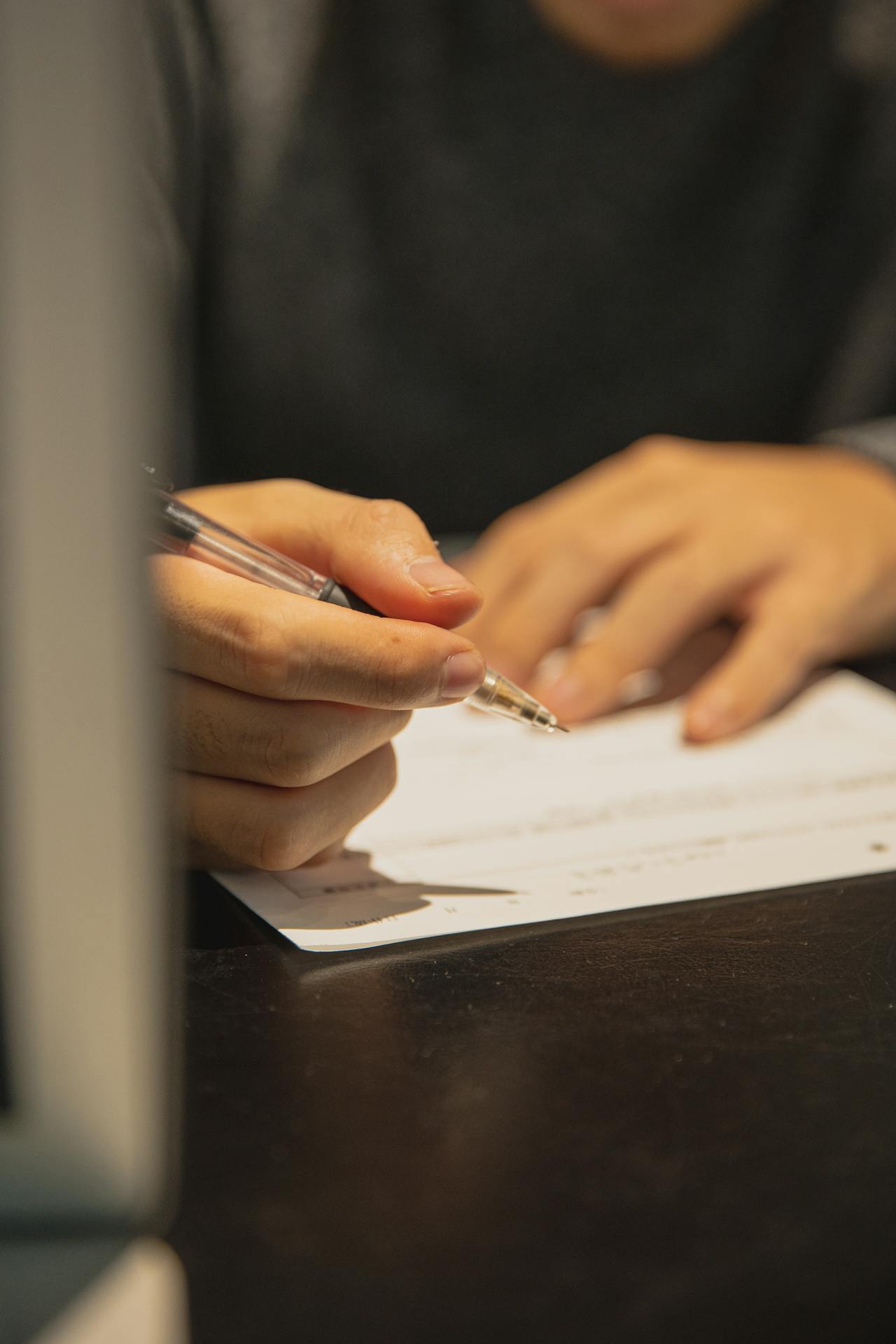 A man on the verge of signing a paper | Source: Pexels