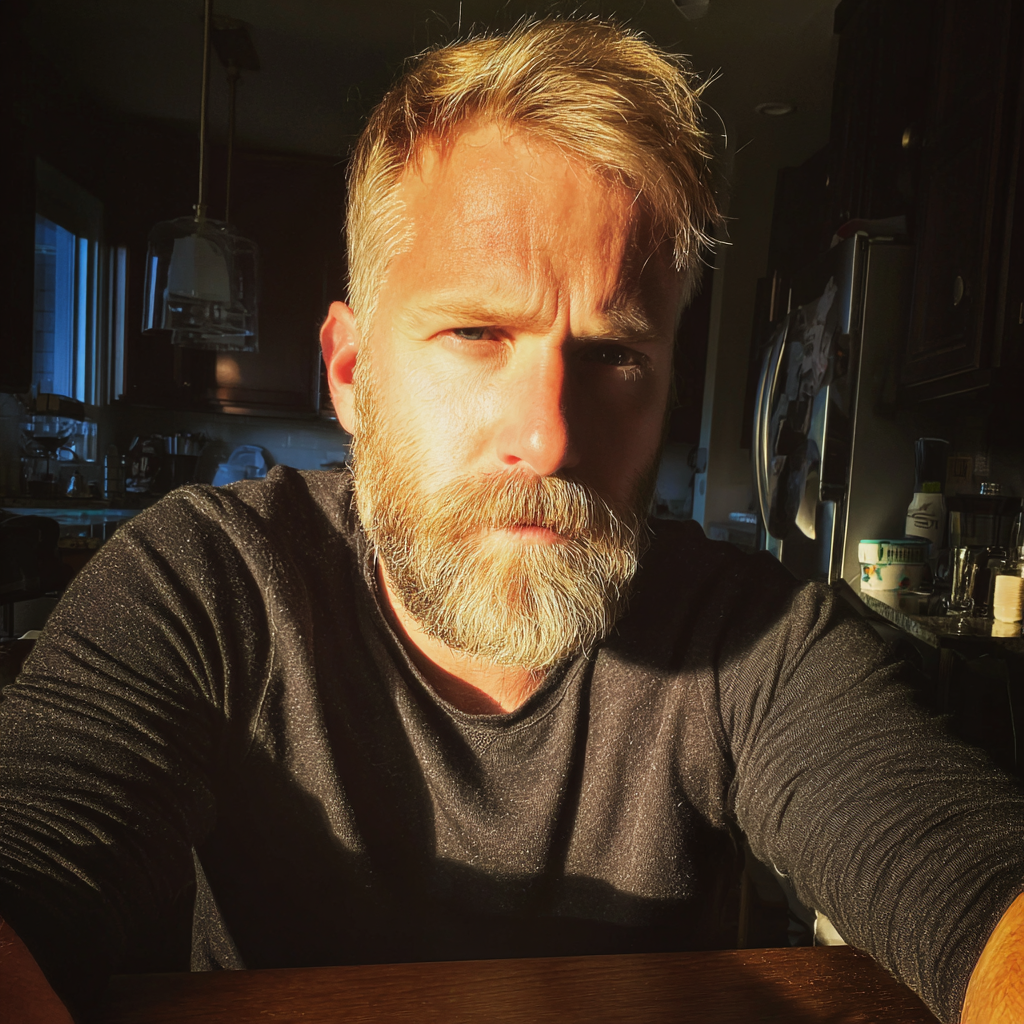 A frowning man sitting at a kitchen table | Source: Midjourney