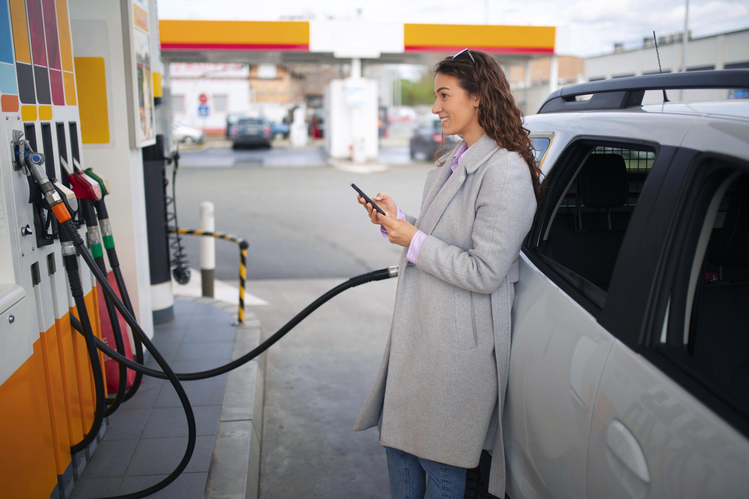 A woman at a gas station | Source: Freepik