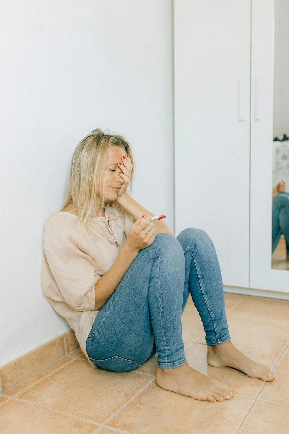 A happy, nervous woman looking at her pregnancy test | Source: Pexels