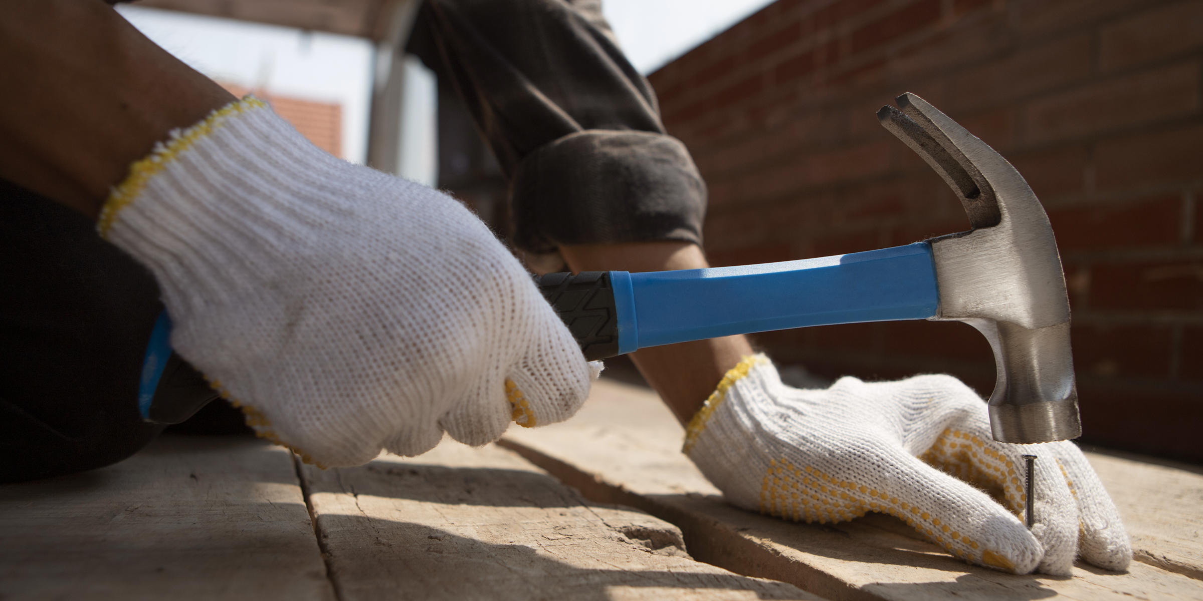 Someone hammering a nail into wood | Source: Freepik