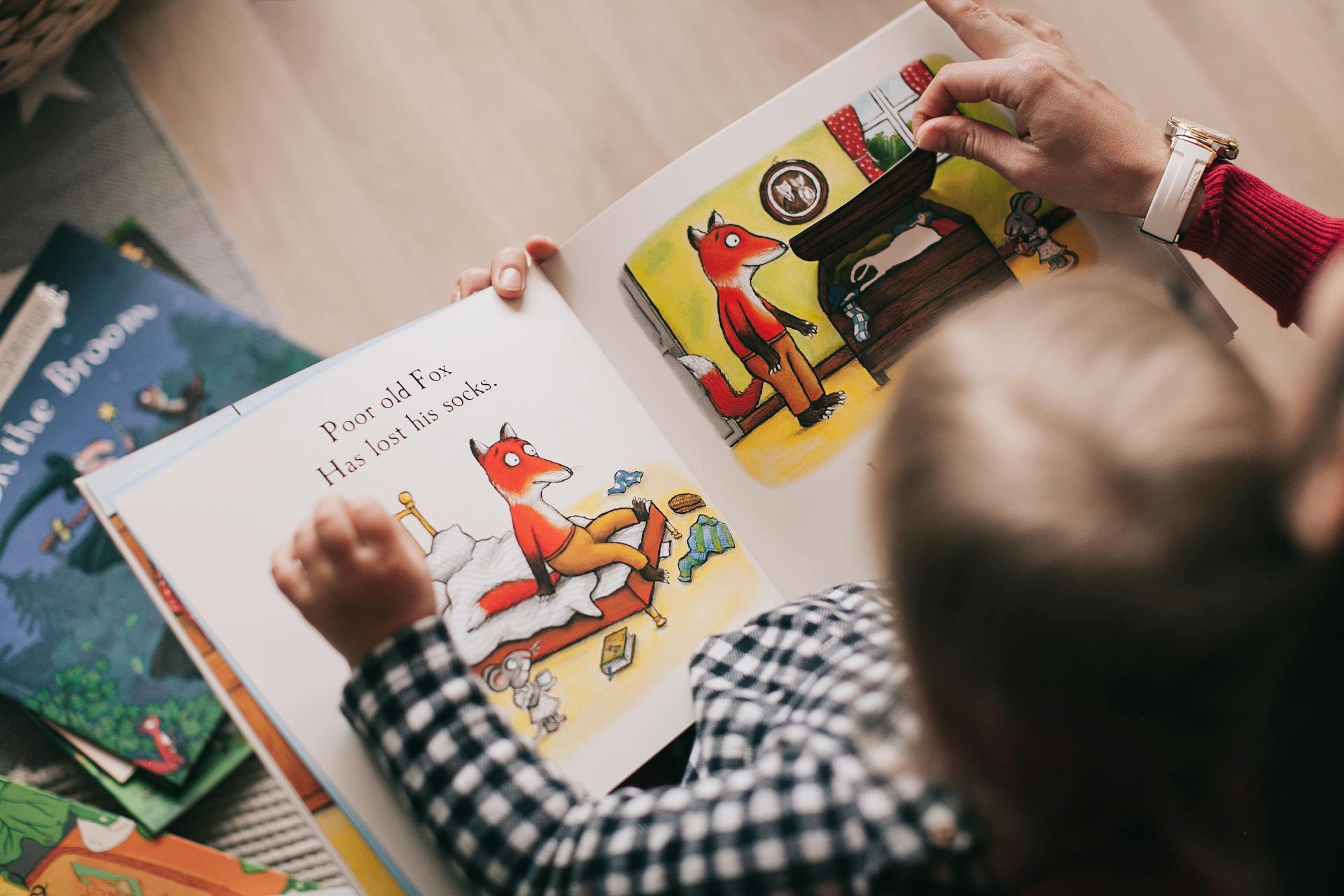 Close-up shot of a person reading a book to a kid | Source: Pexels