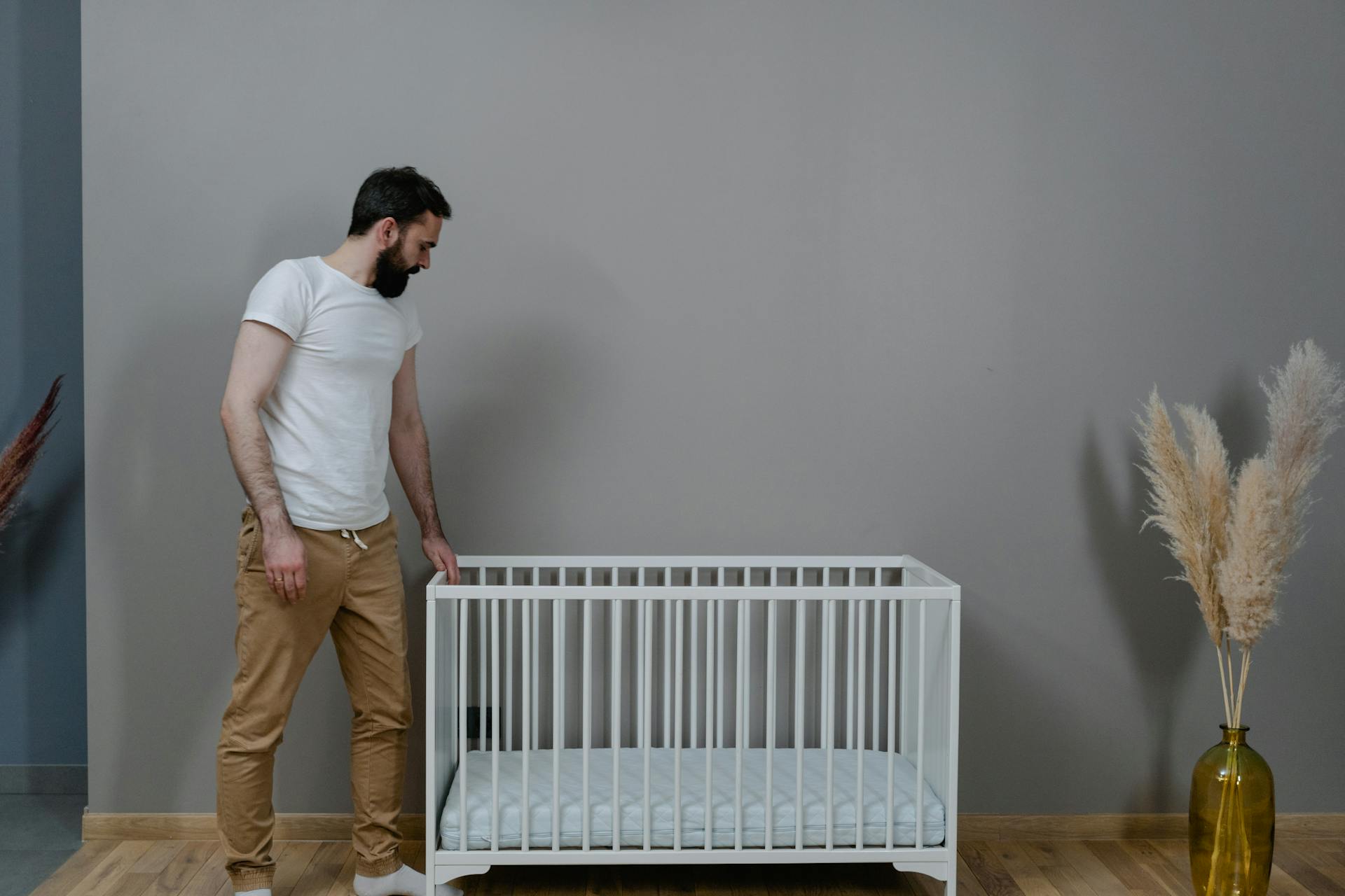 A man standing near a crib | Source: Pexels