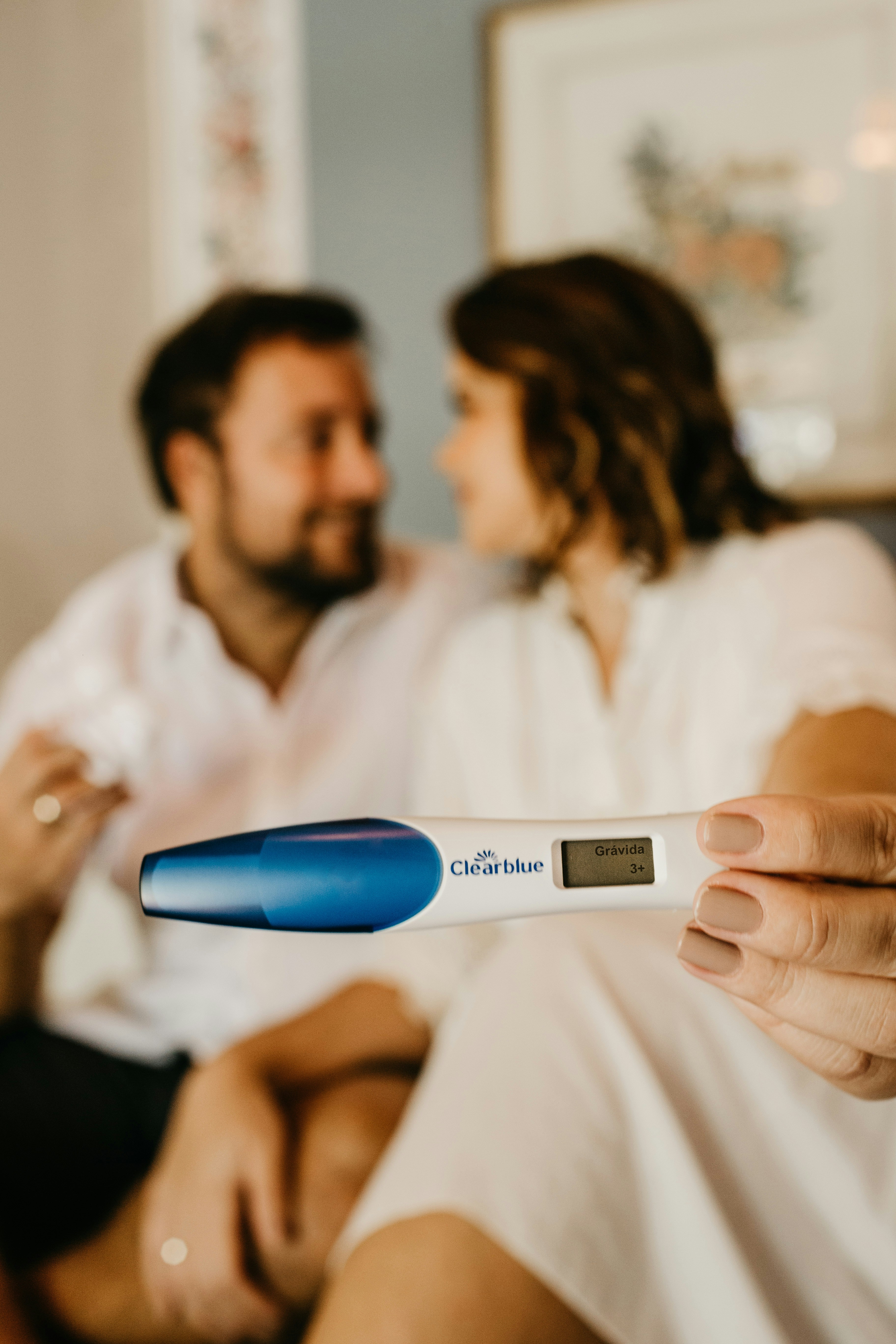 A couple showing off a positive pregnancy test | Source: Unsplash