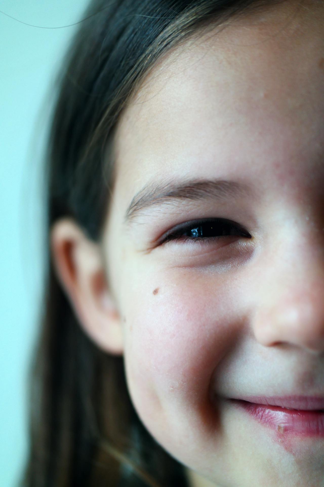Cropped shot of a girl smiling | Source: Pexels
