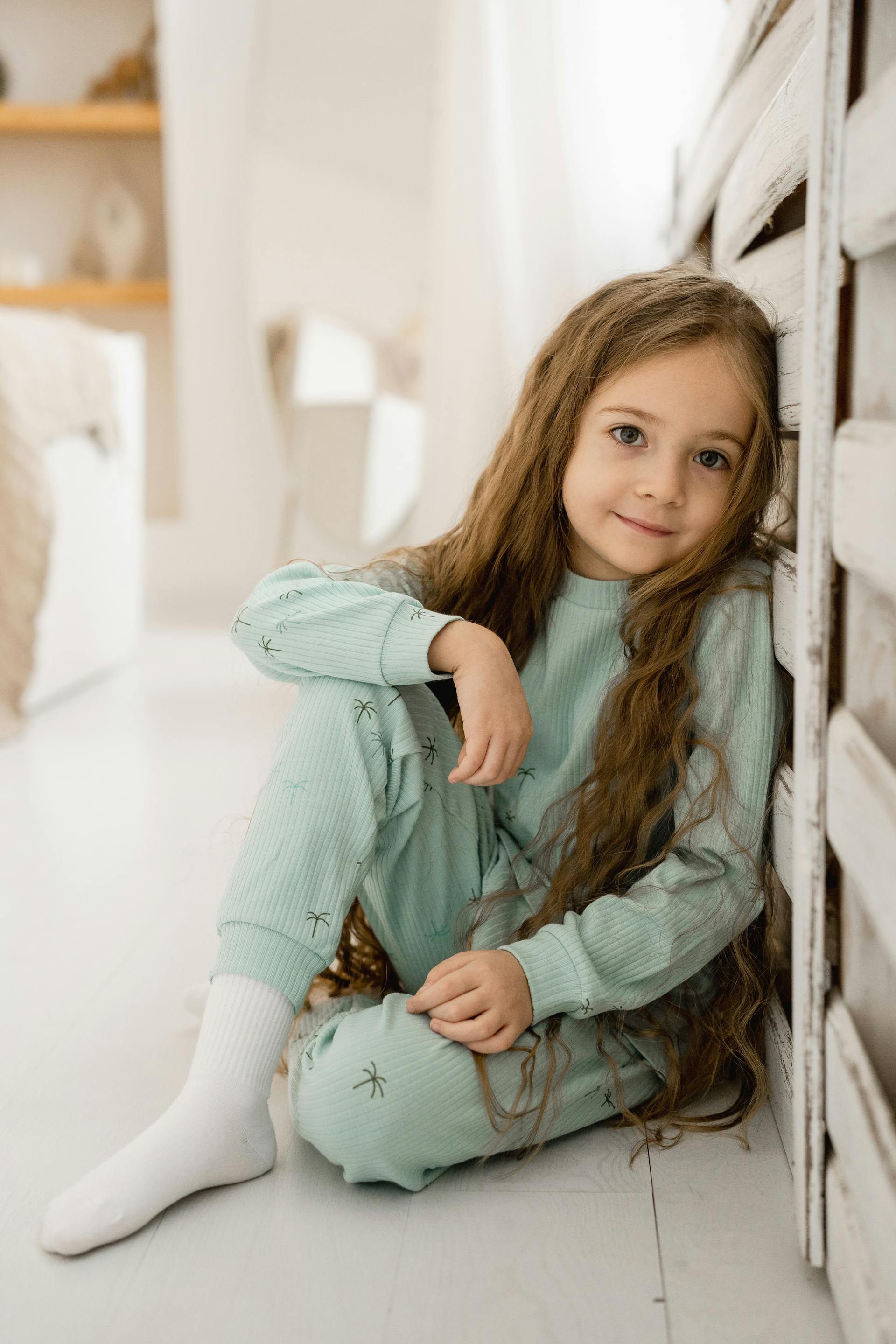 A smiling little girl with long hair | Source: Pexels