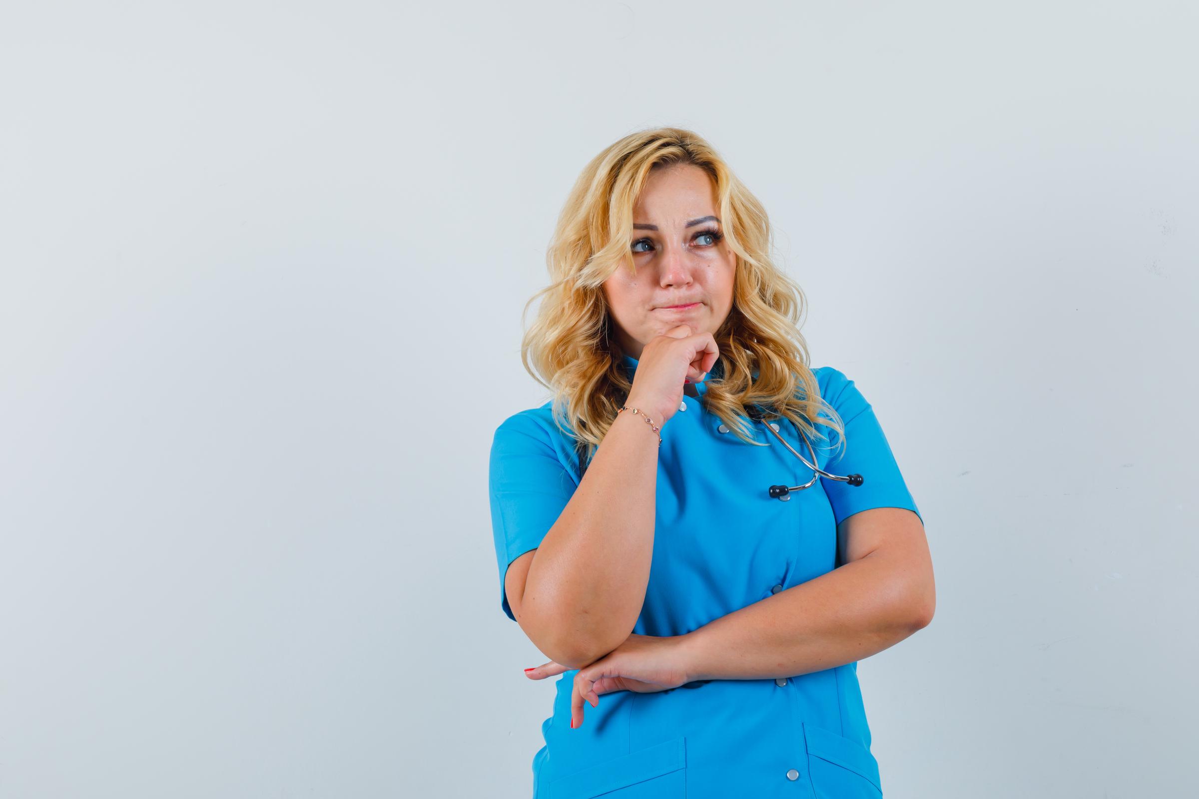A lady doctor lost in thought | Source: Freepik