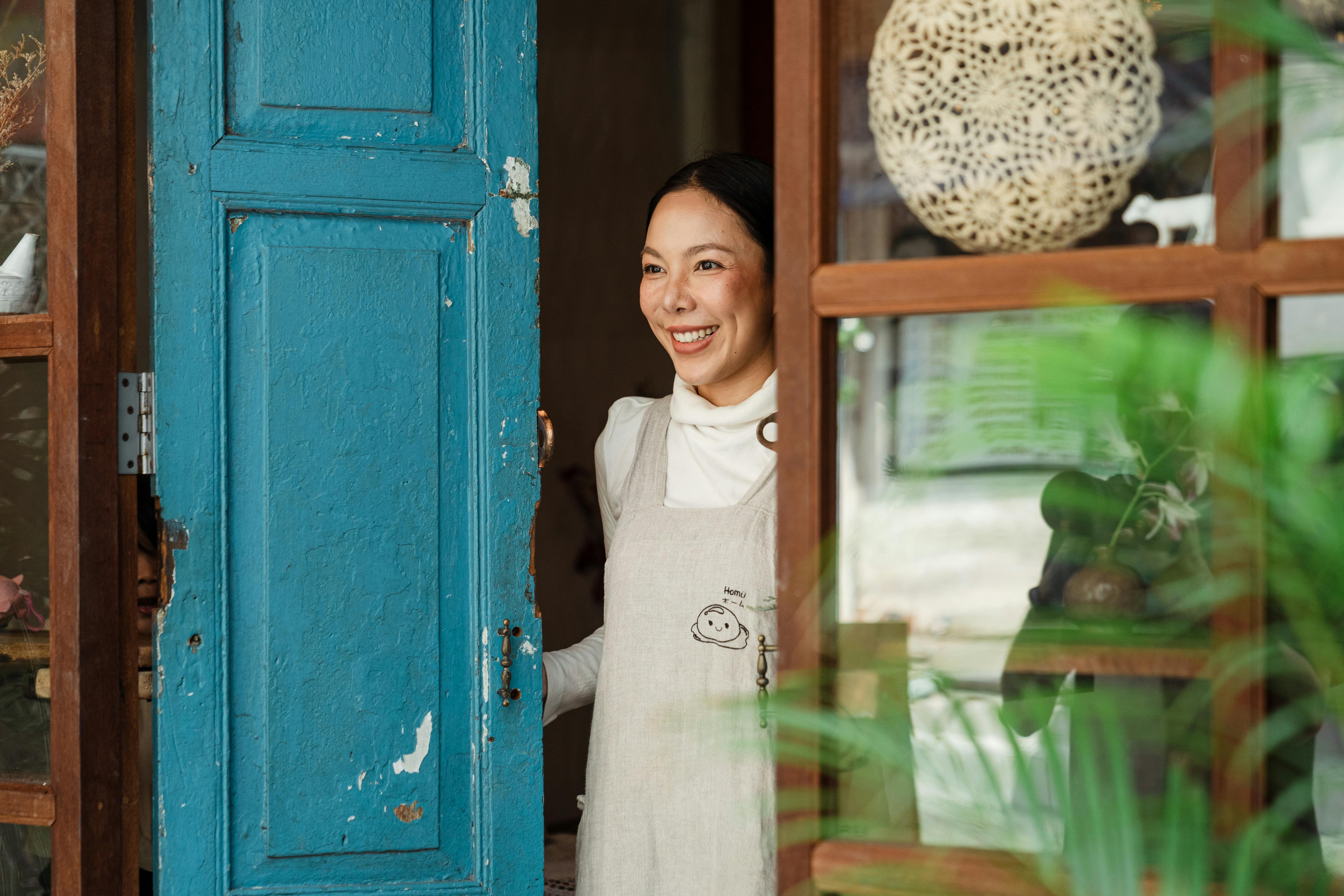 A woman opening her front door | Source: Pexels