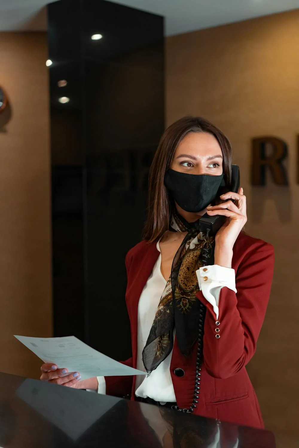 A receptionist talking on her phone | Source: Pexels