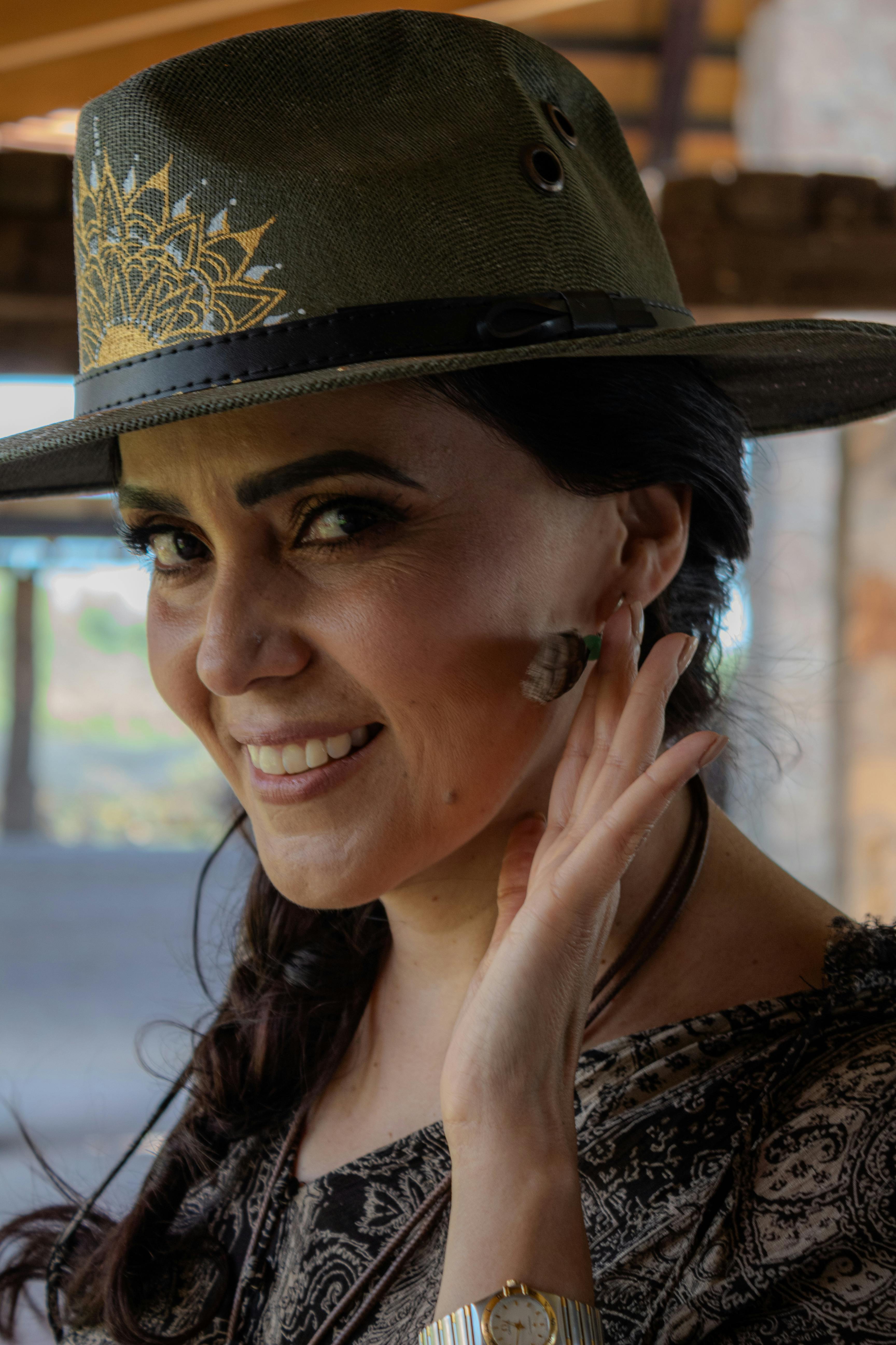 A happy woman showing off her earrings | Source: Pexels