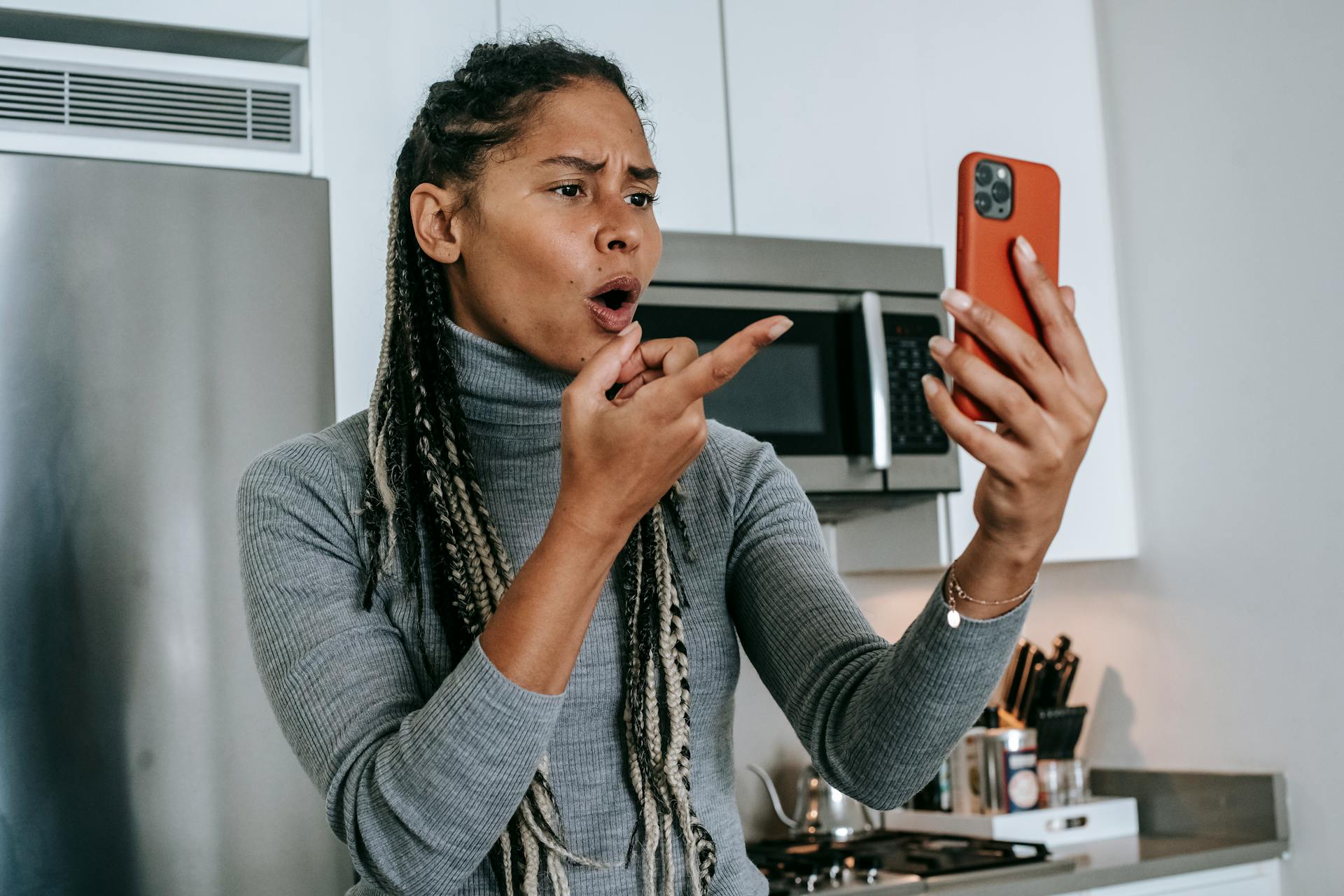 An upset woman looking at her phone | Source: Pexels