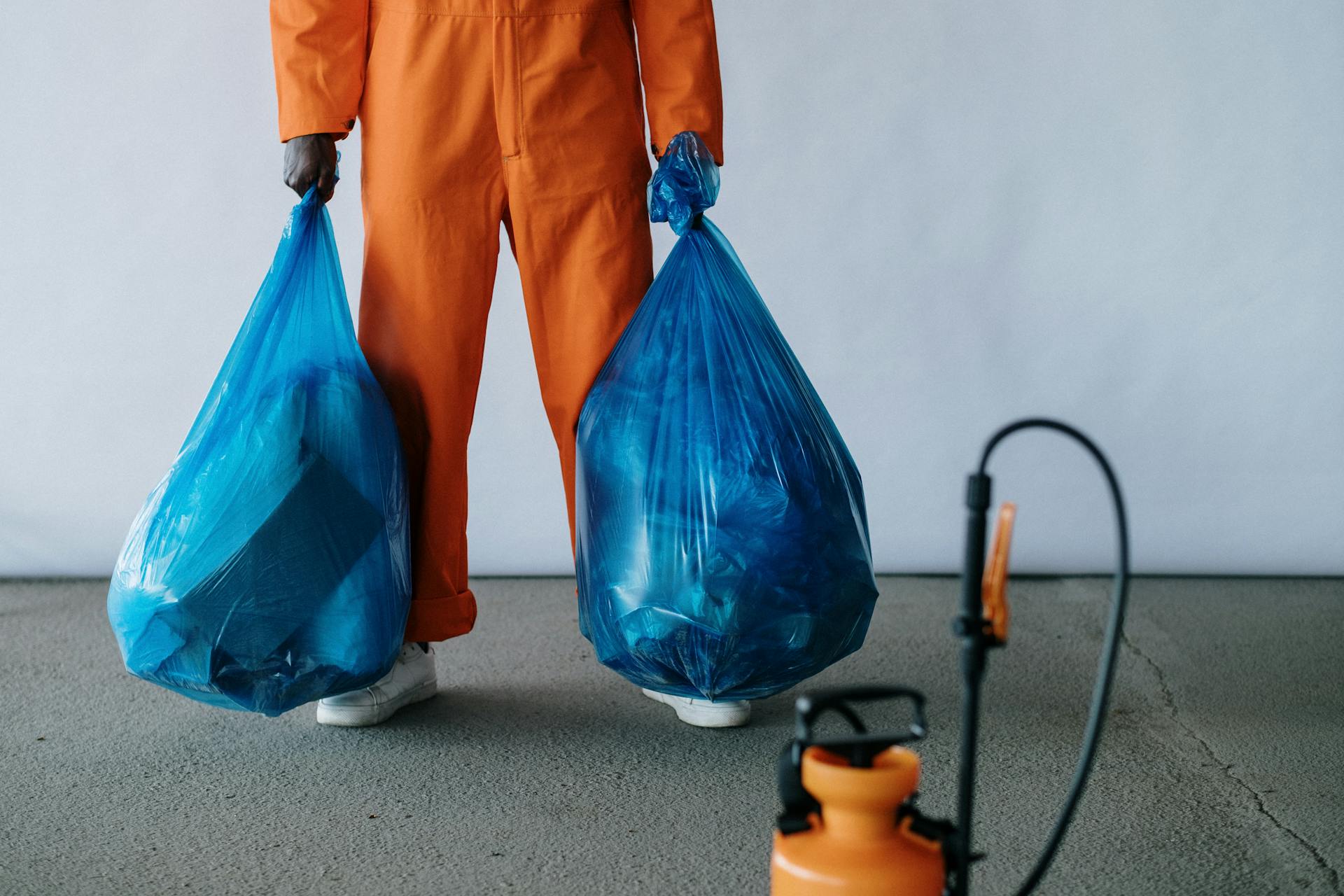 A janitor holding garbage bags | Source: Pexels