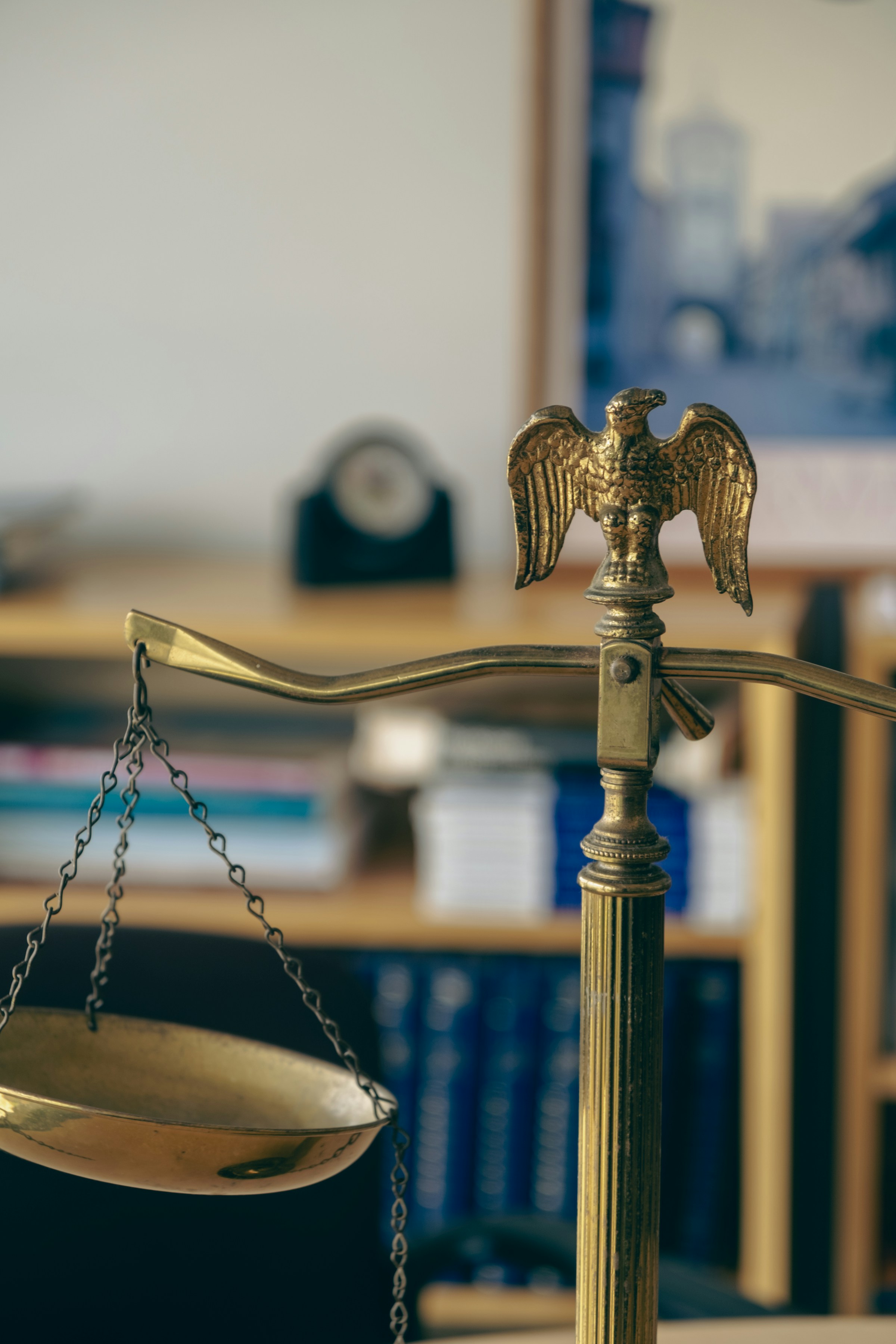 A golden scale with an eagle on top of it | Source: Unsplash