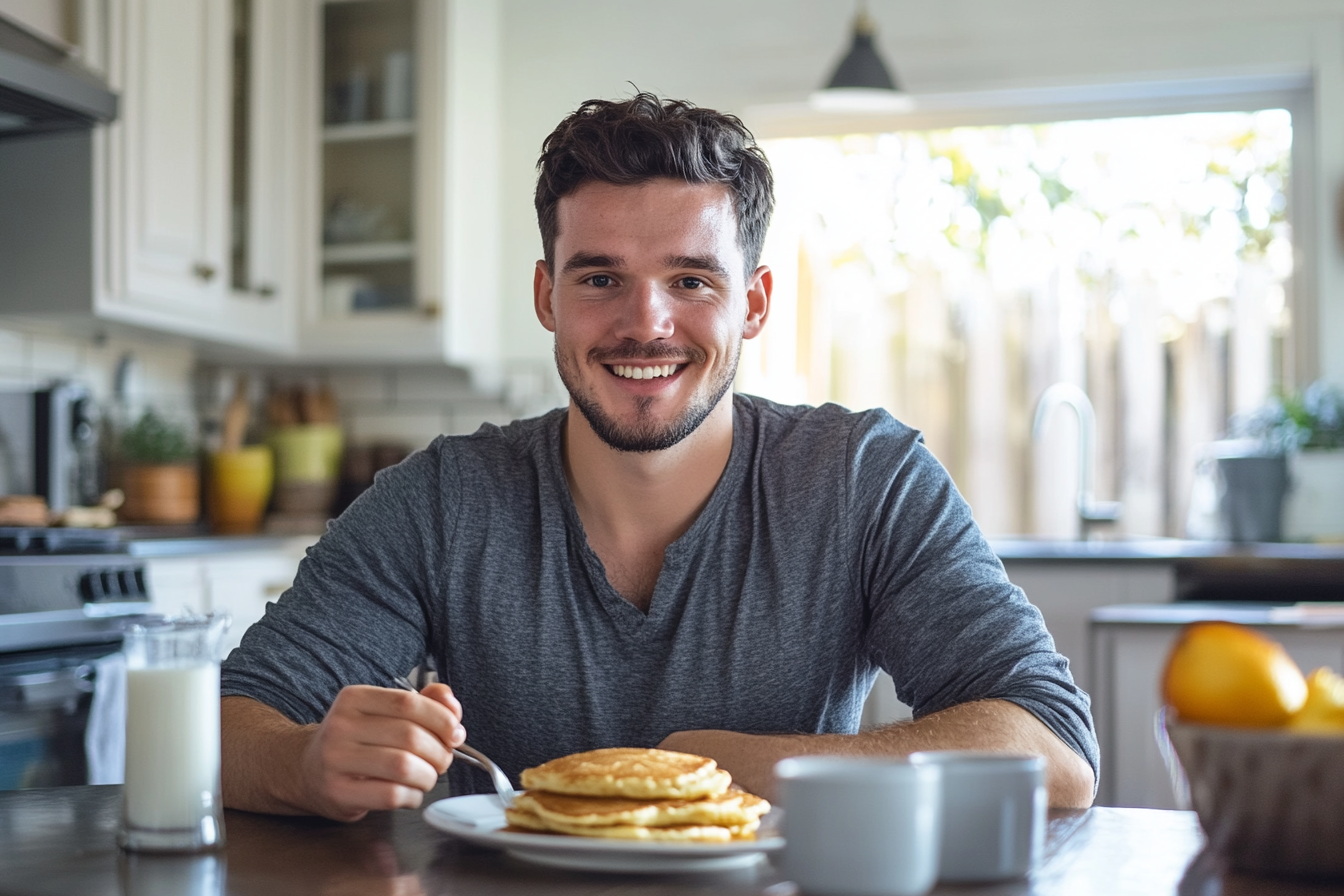 Man smiling while eating breakfast | Source: Midjourney