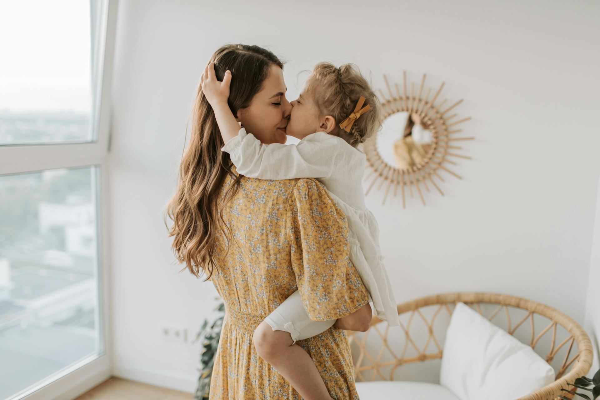 A woman kissing her daughter | Source: Pexels