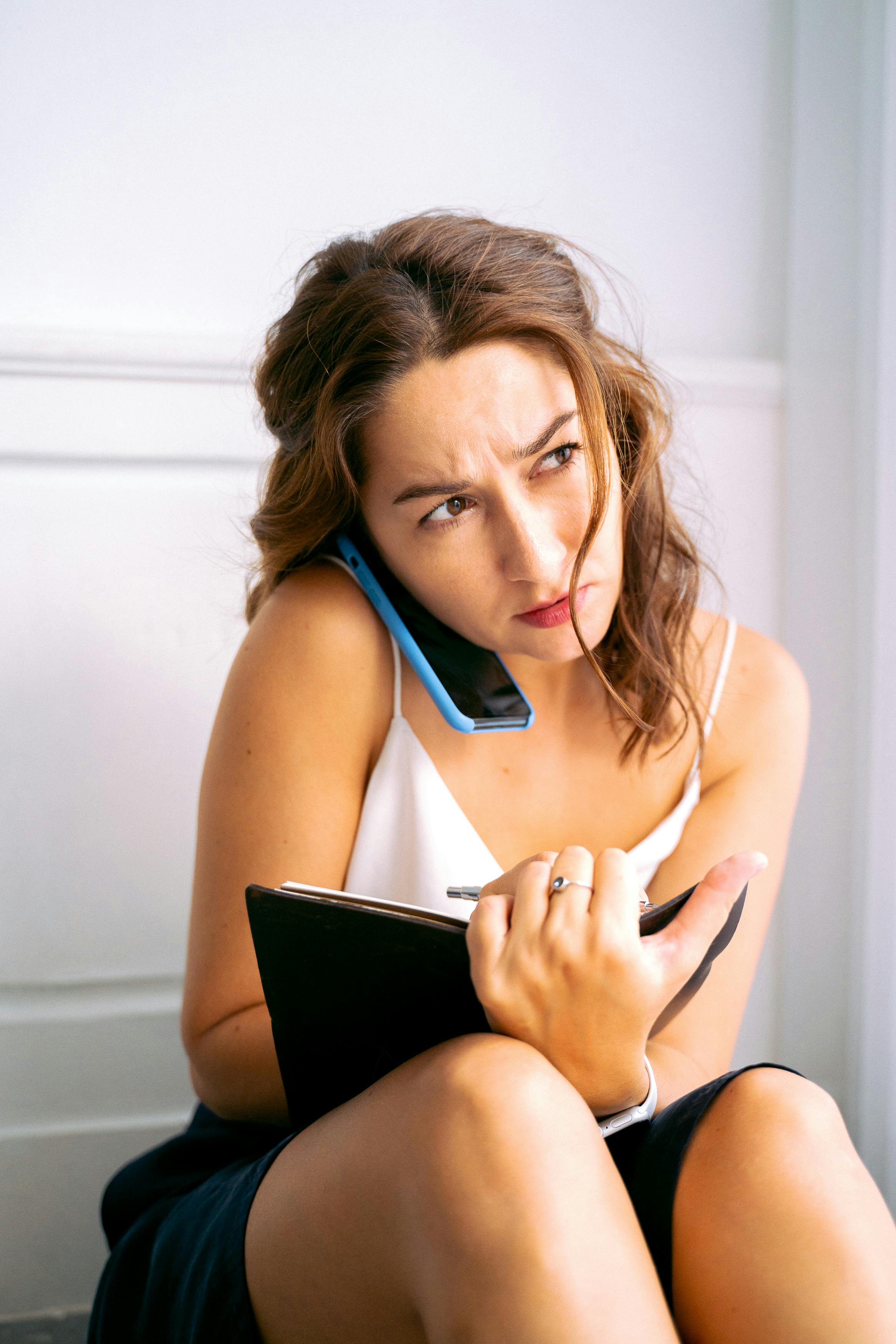 A stressed woman on a call | Source: Pexels