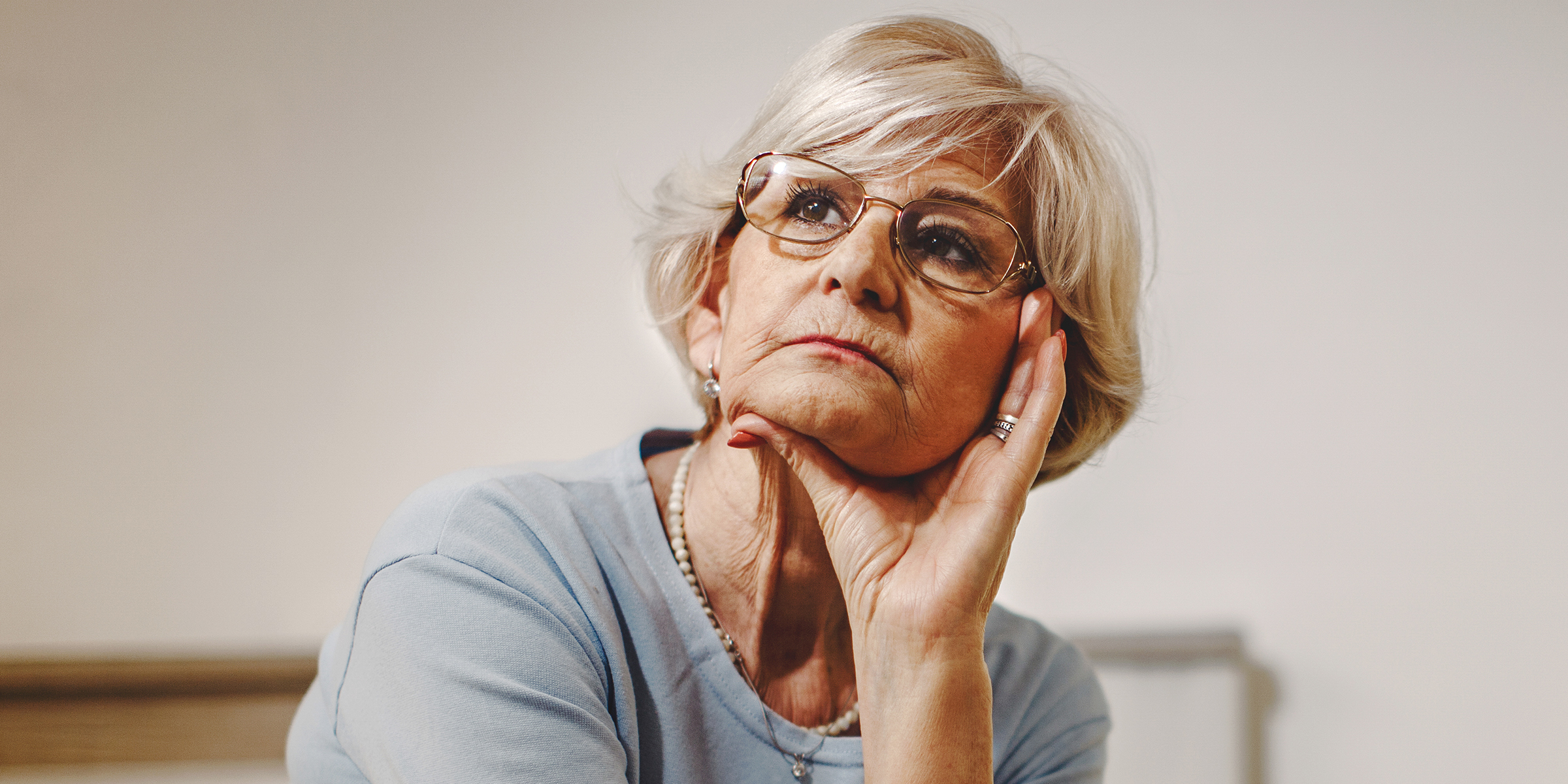 A thoughtful older woman looking pensive | Source: Shutterstock