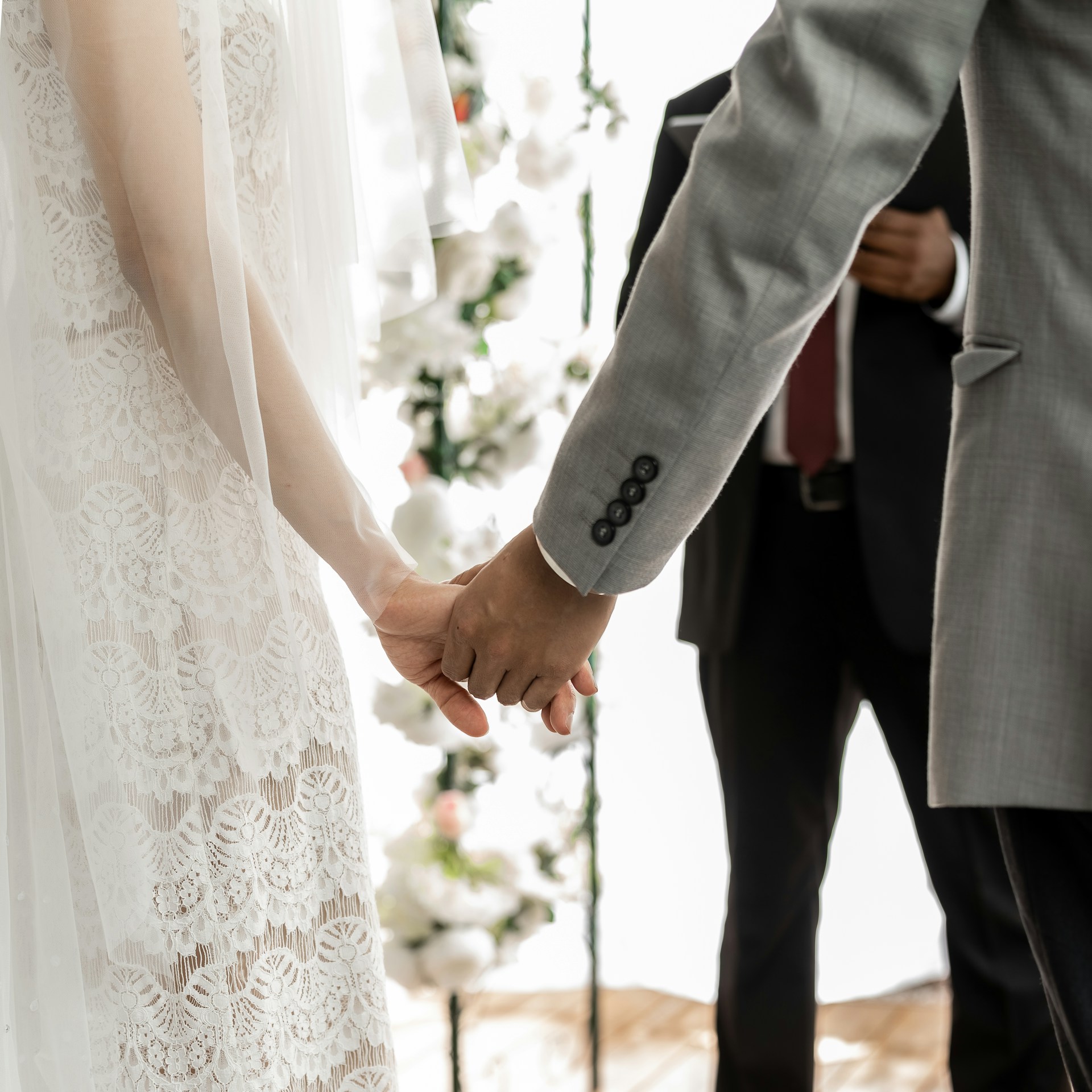 A groom holding his bride's hand | Source: Unsplash