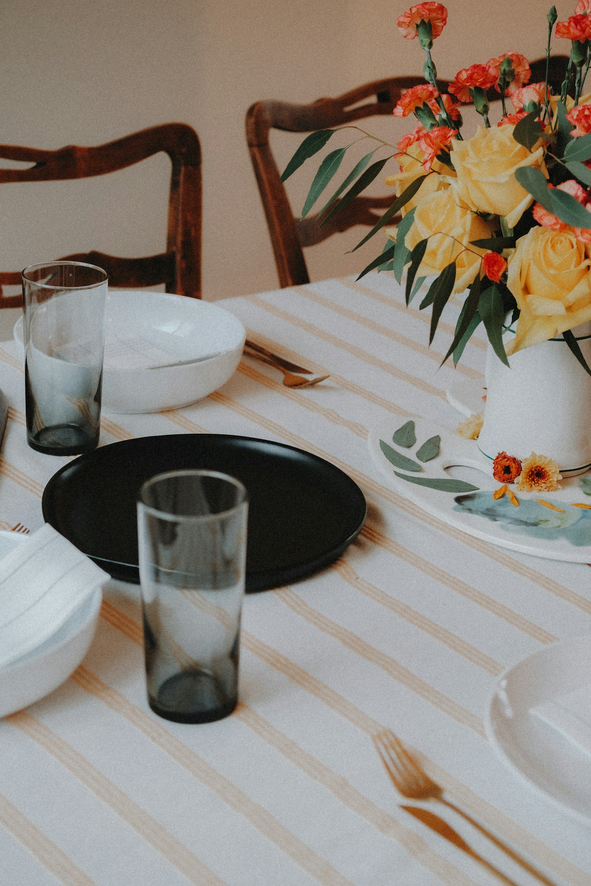 A table set with plates, glasses, and cutlery | Source: Unsplash