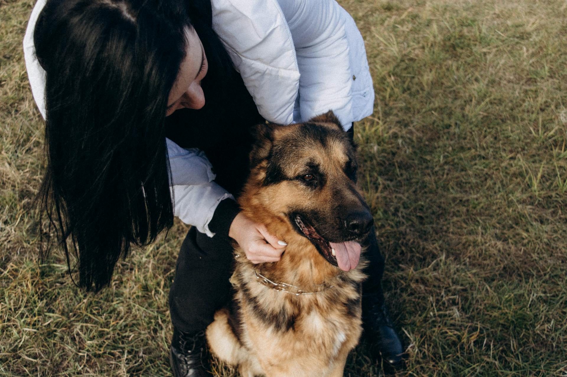 A woman holding her dog | Source: Pexels