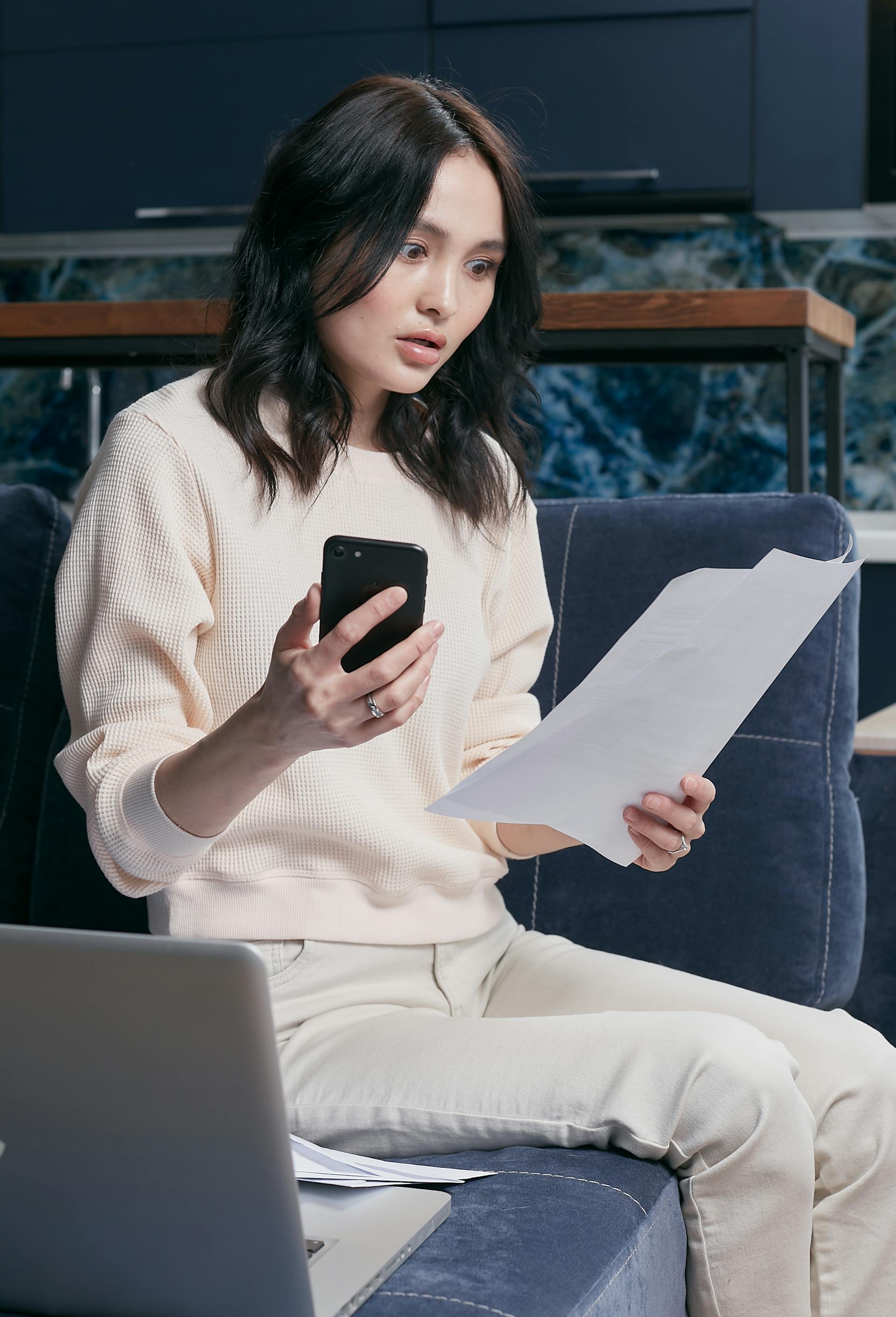 A shocked woman looking at documents | Source: Pexels