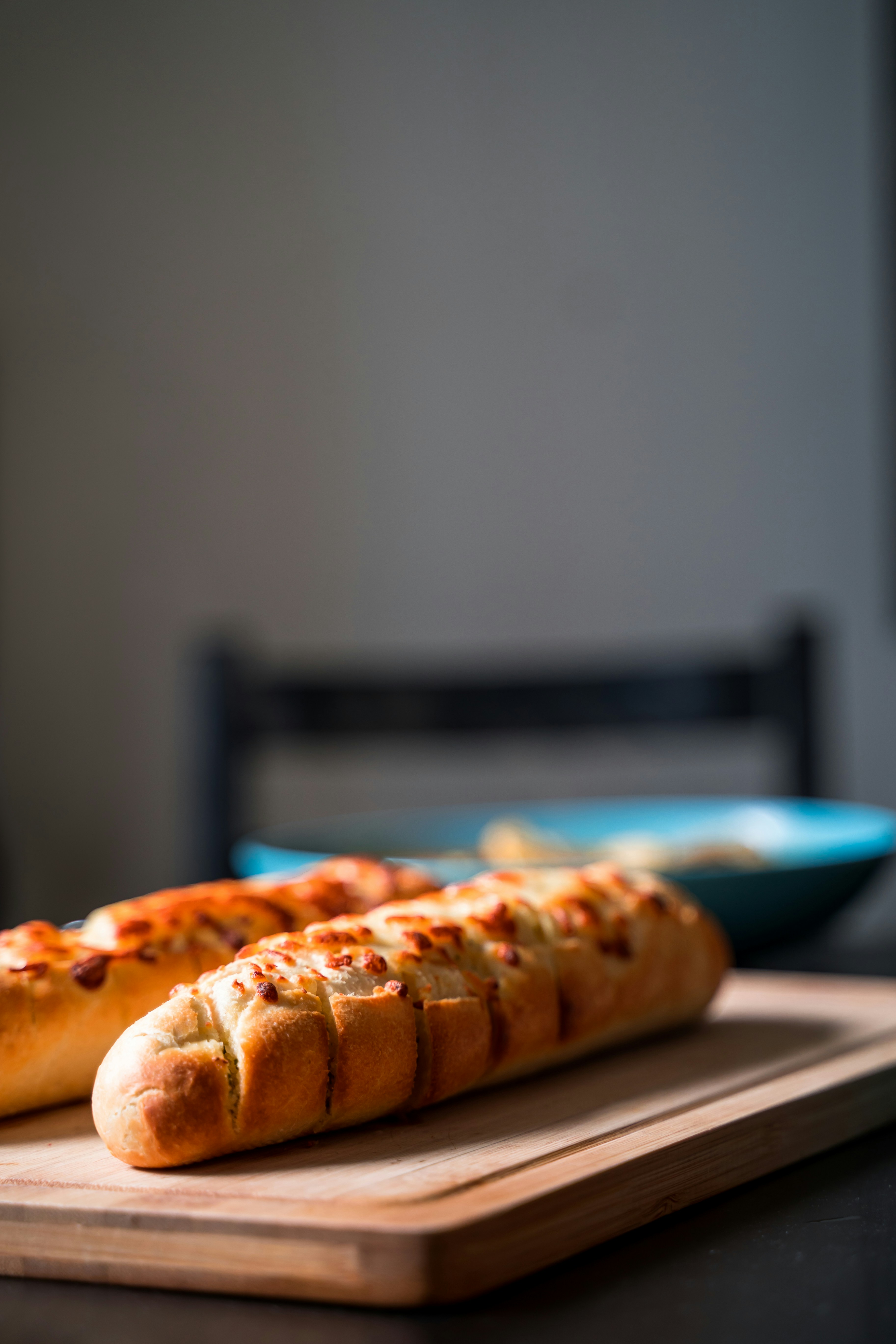 Garlic bread on a wooden board | Source: Unsplash