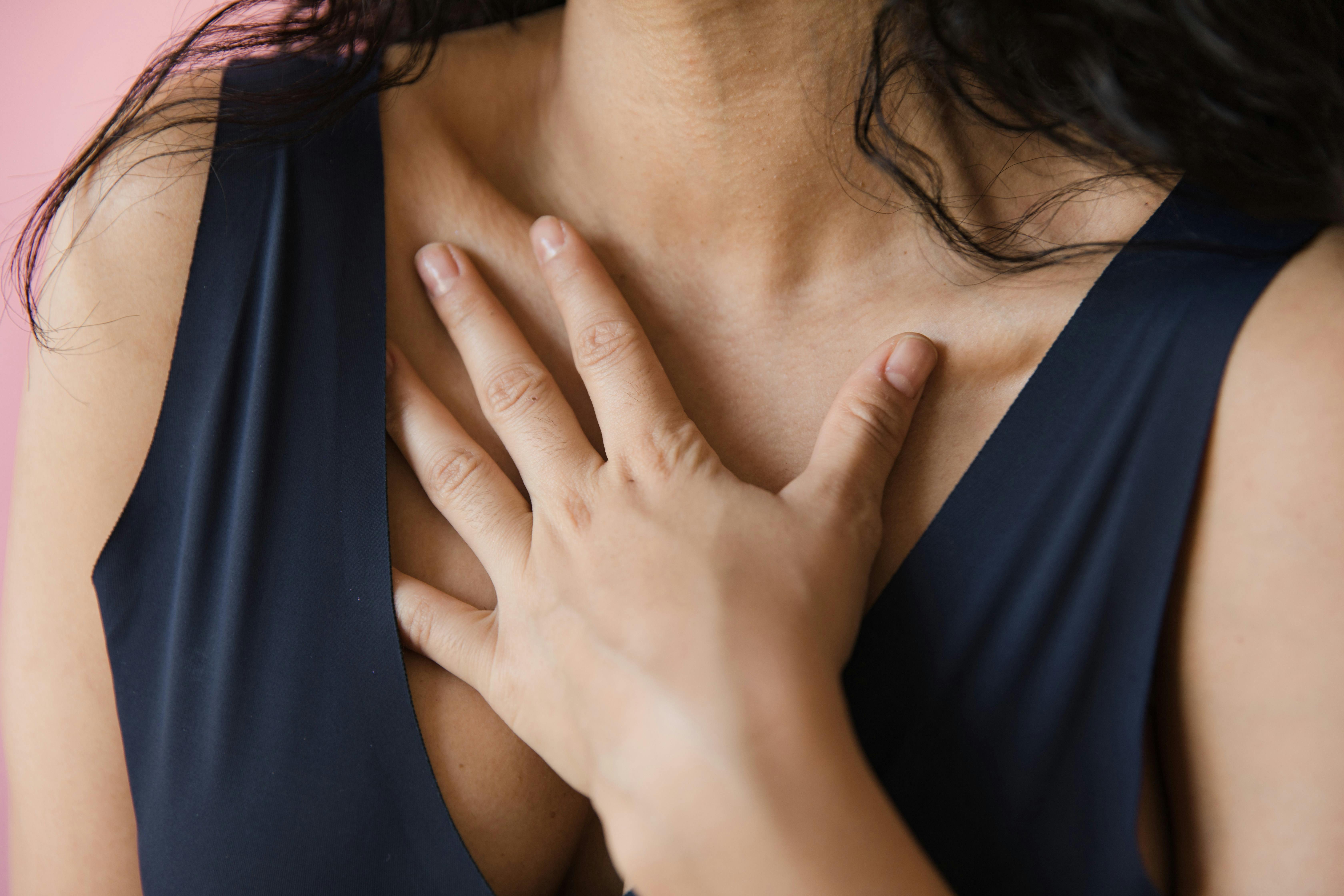 A woman's hand touching her chest | Source: Pexels