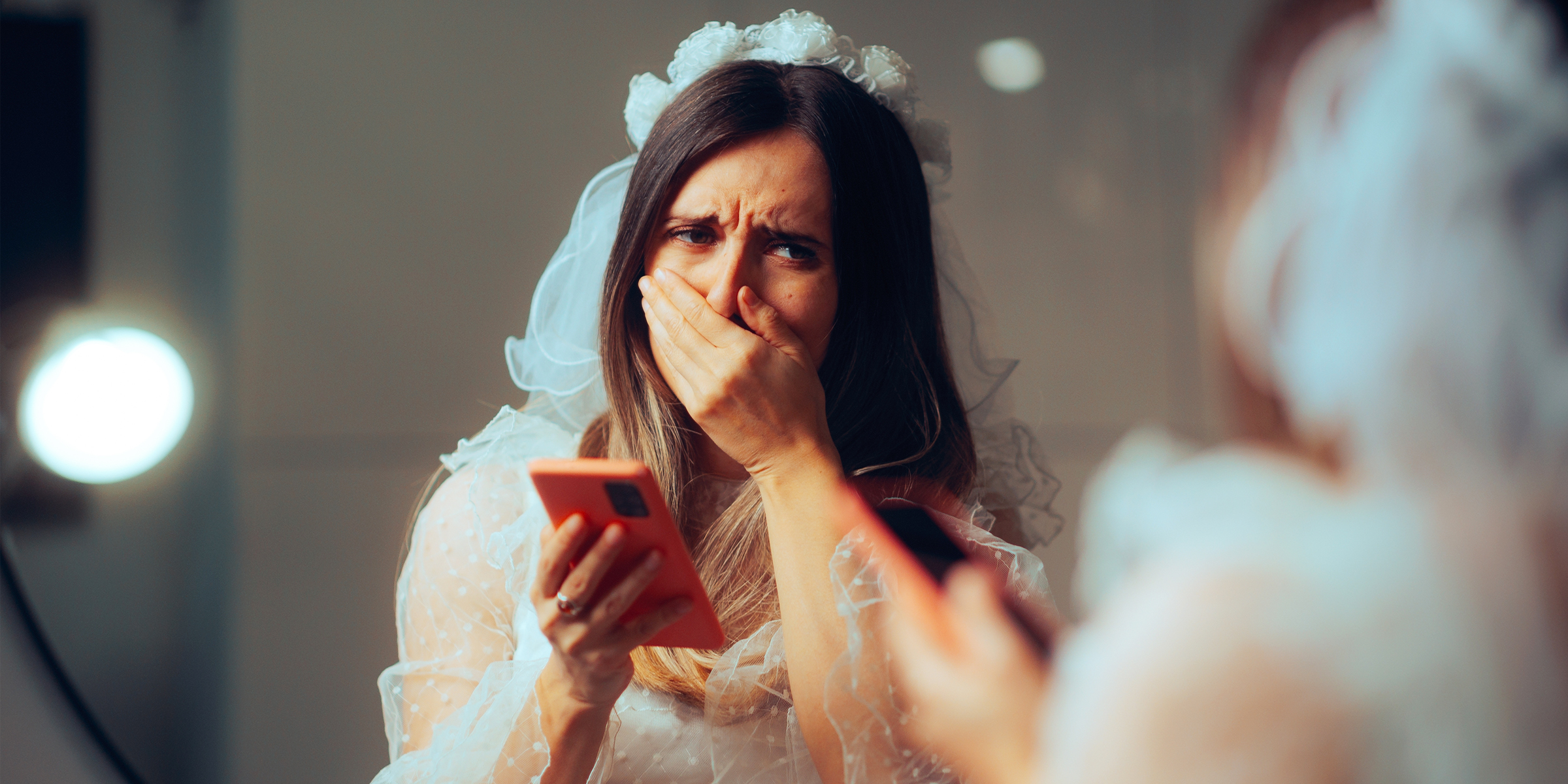 A woman reacting to a message on her phone | Source: Shutterstock