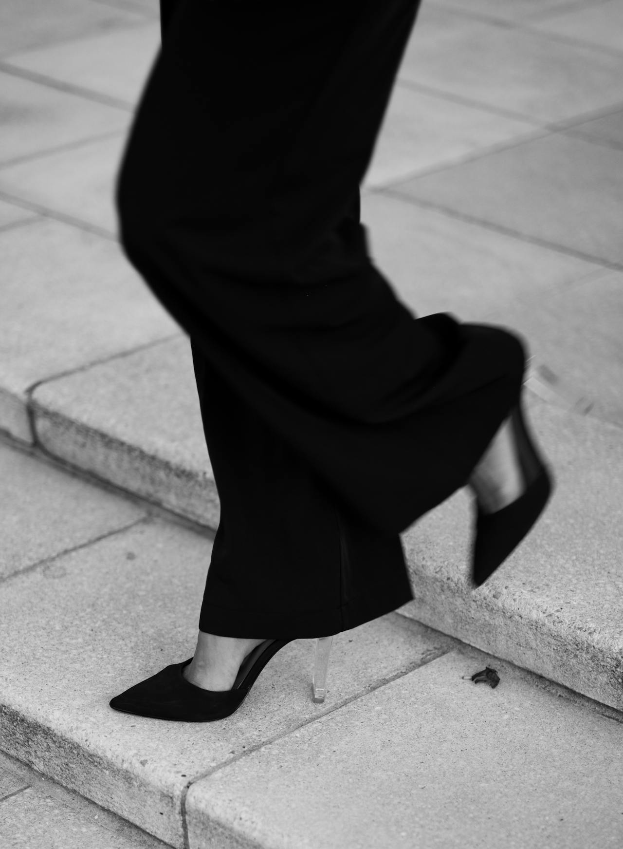 Grayscale shot of a woman walking away | Source: Pexels