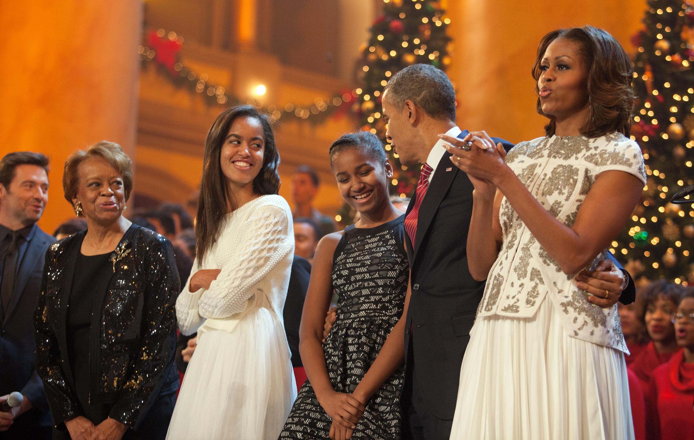 Barack Obama and Michelle Obama, along with Michelle's mother Marion Robinson and their daughters Malia (left) and Sasha, sing during the finale of TNT's "Christmas in Washington" on December 15, 2013, in Washington, DC. | Source: Getty Images